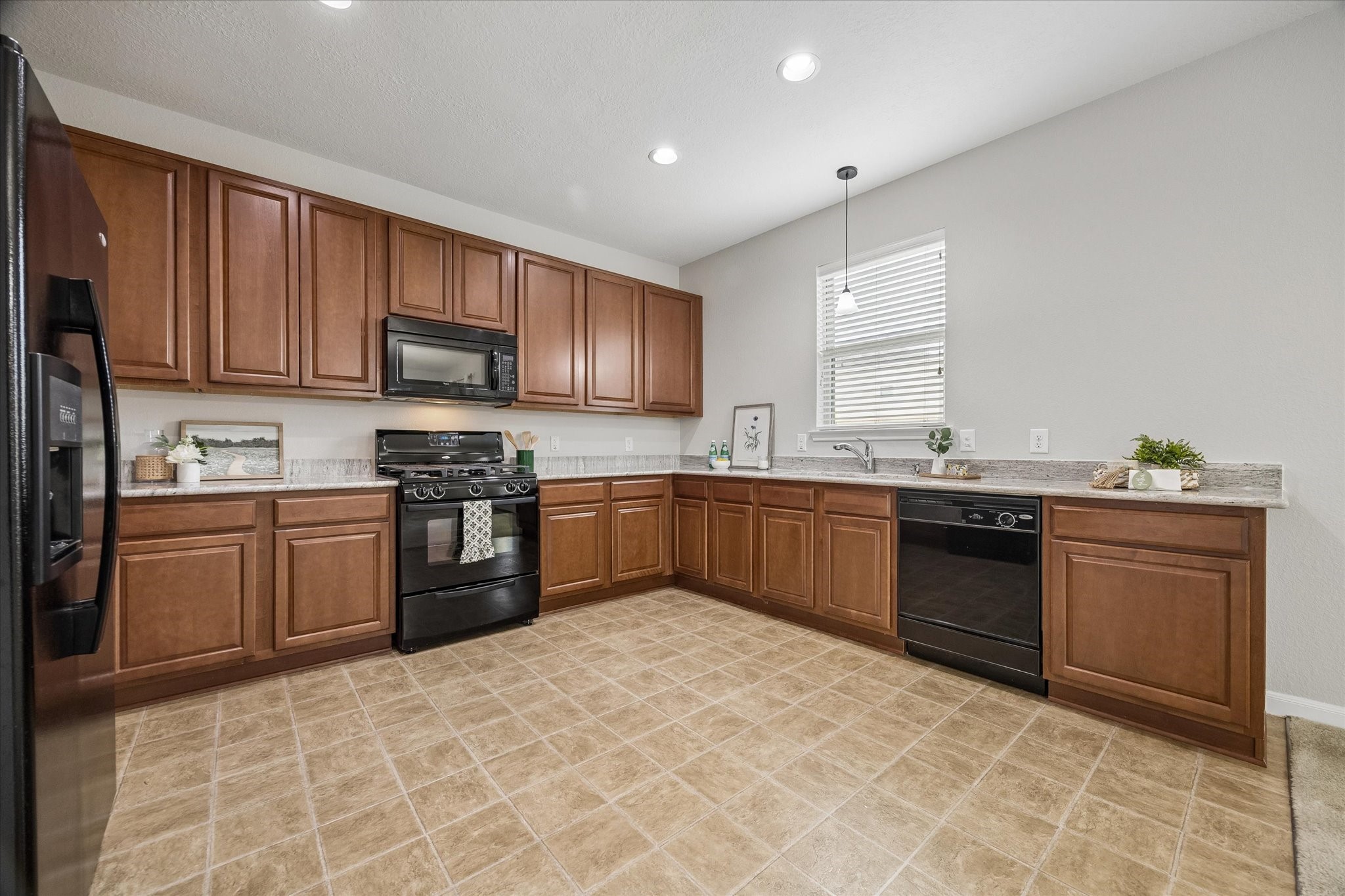Spacious kitchen featuring granite countertops and abundant cabinetry.