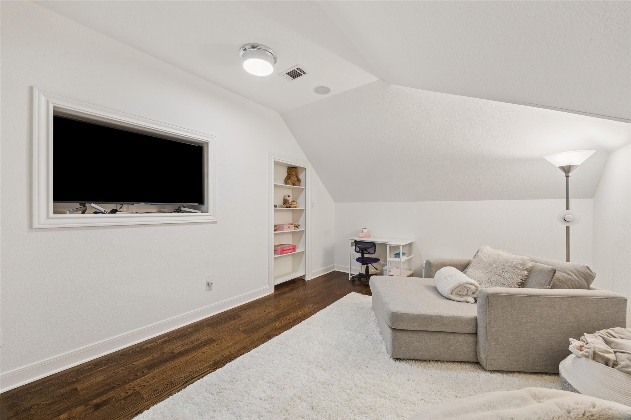 This cozy, quiet space features custom built-ins, a closet, and floor-to-ceiling shelving, offering endless possibilities for use.