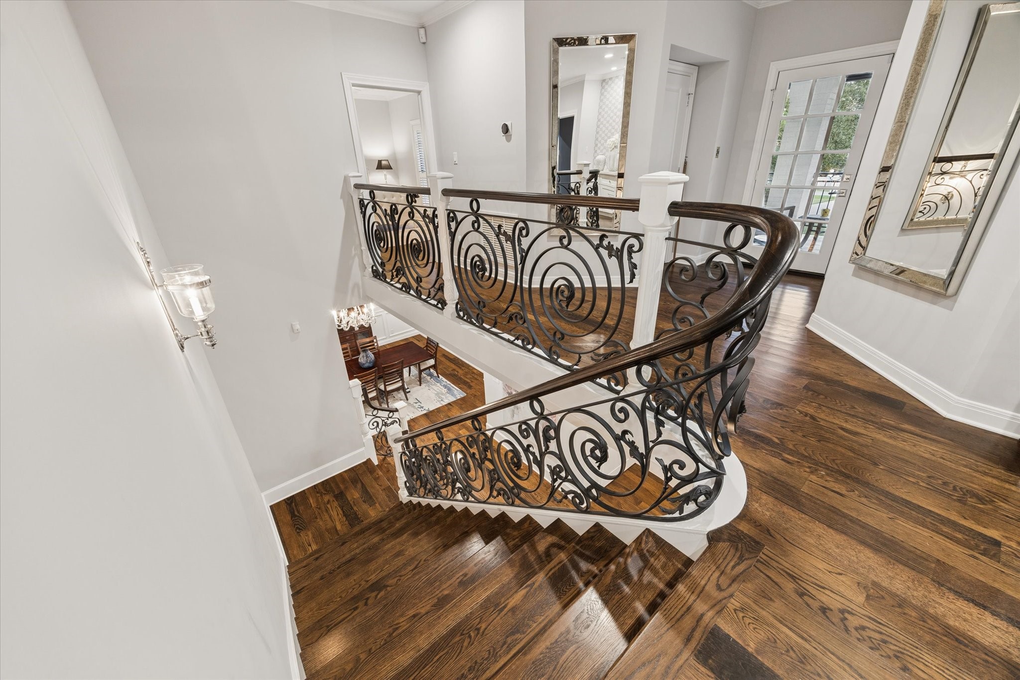 View of stairwell and landing, Door to balcony and elevator.