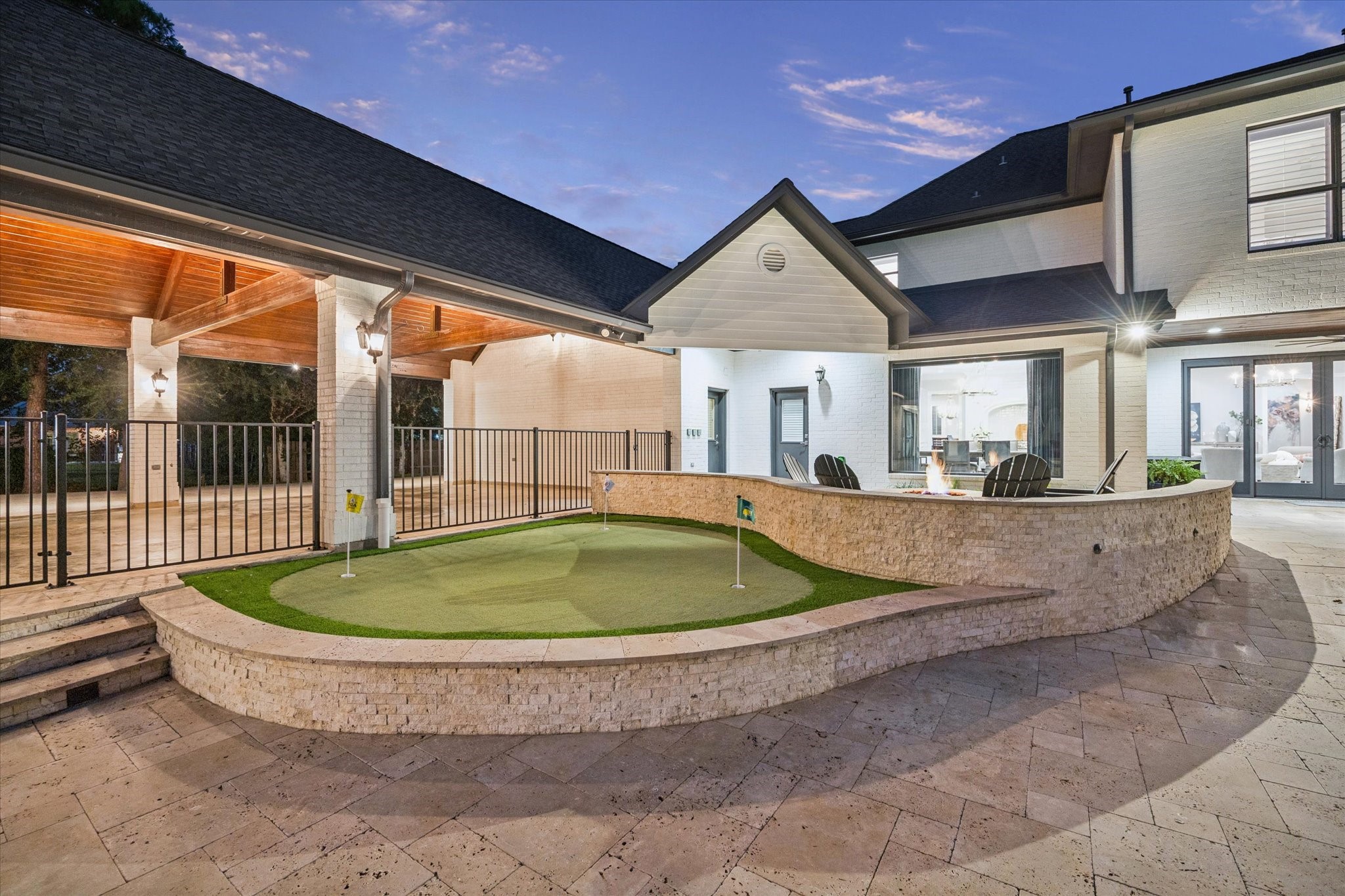 Perfect your short game on the putting green while enjoying views of the pool and backyard.