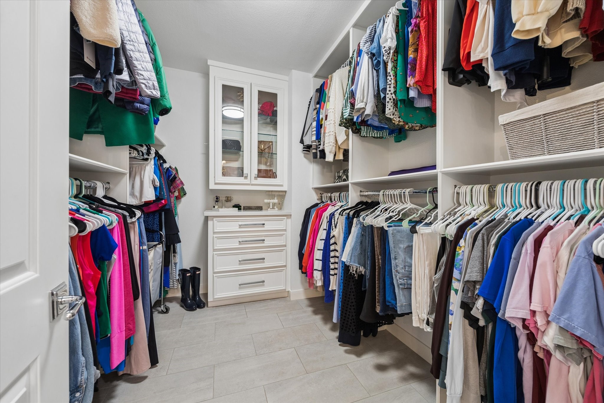 One of two walk-in closets featuring custom built-ins located in the primary suite on the second floor.