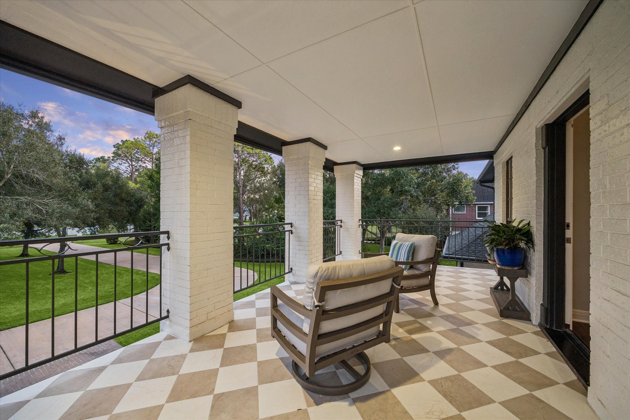 Captivating balcony view providing an elevated perspective overlooking the beautifully landscaped front grounds.