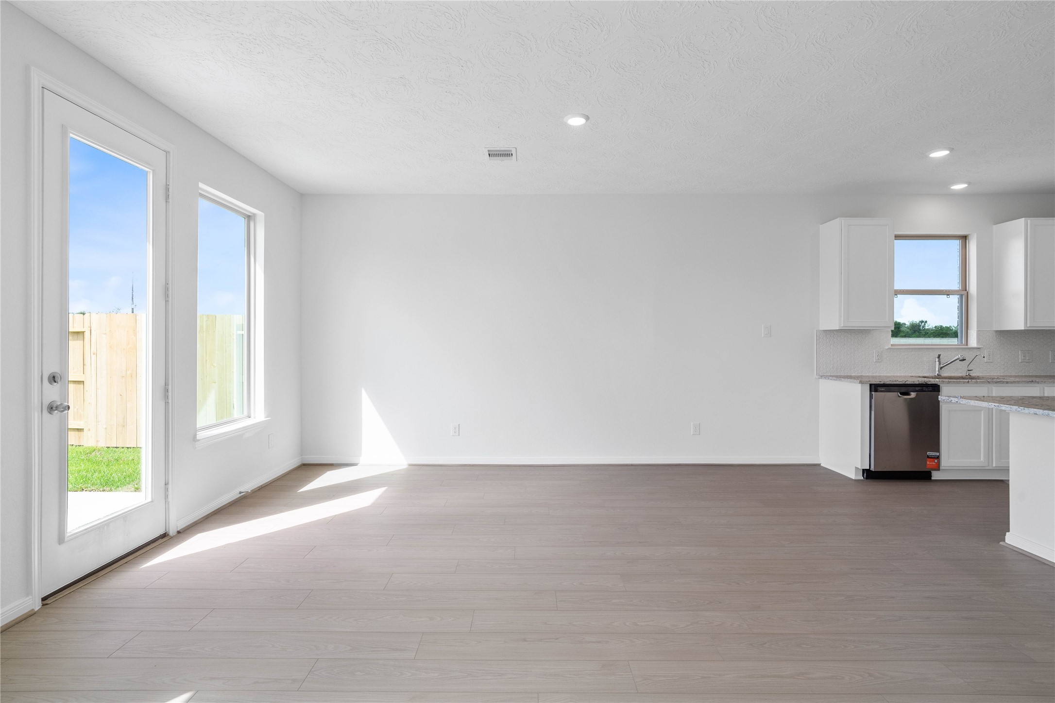 Make memories gathered around the table with your family and friends! This dining room features high ceilings, large windows, and easy access to the kitchen and family room. A patio door is also featured through this dining area into the backyard green space.