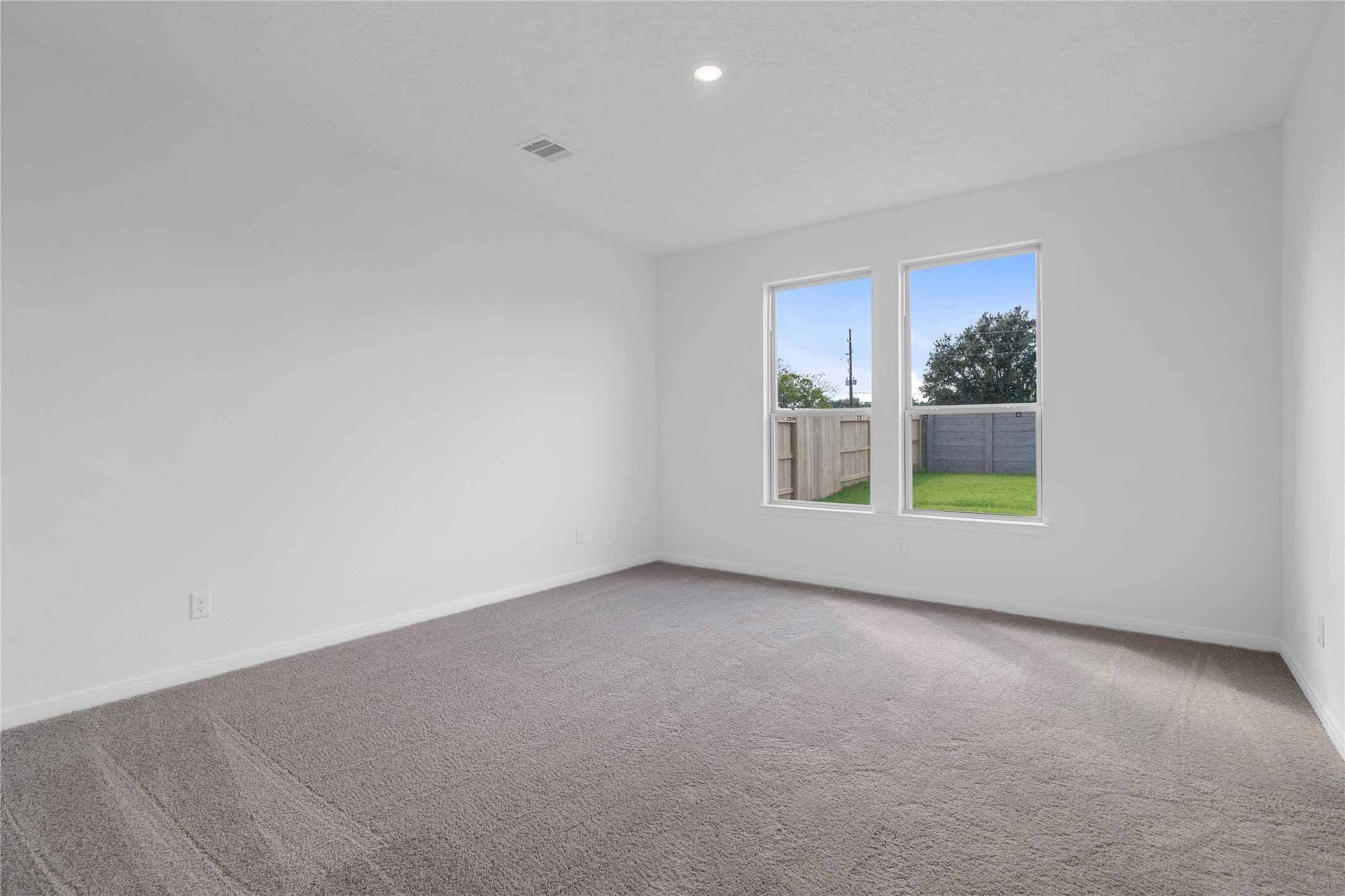 Come and unwind after a long day in this magnificent and spacious primary suite! This room features plush carpet, neutral paint, high ceiling, and large windows.