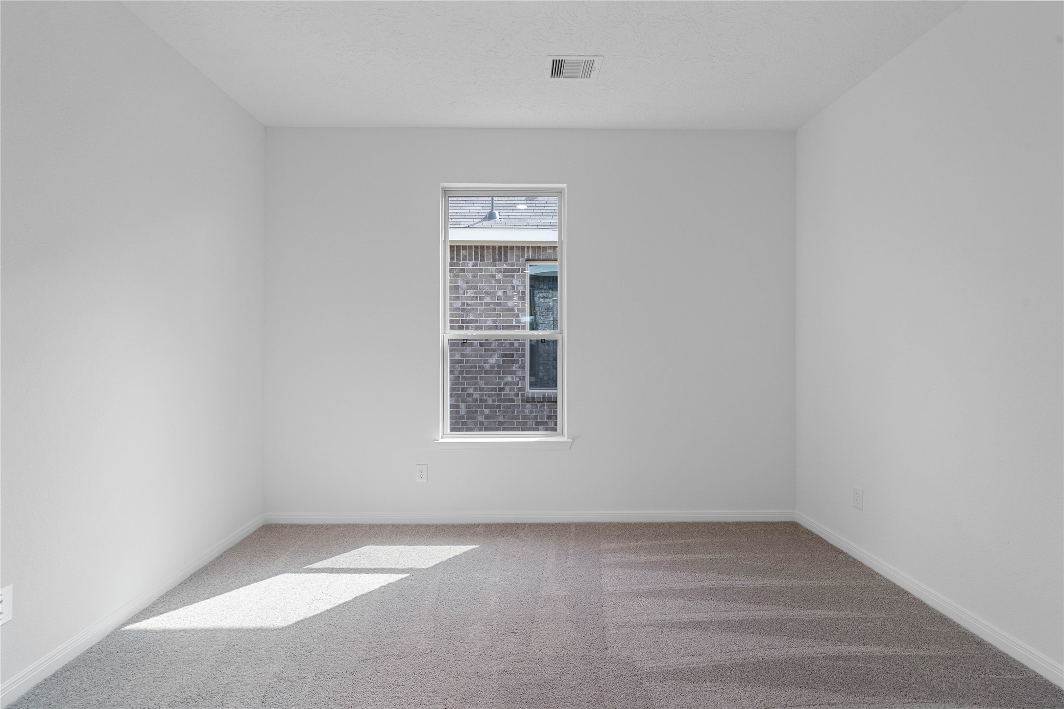 Secondary bedroom features plush carpet, neutral paint, recessed lighting, window, and closet space.
