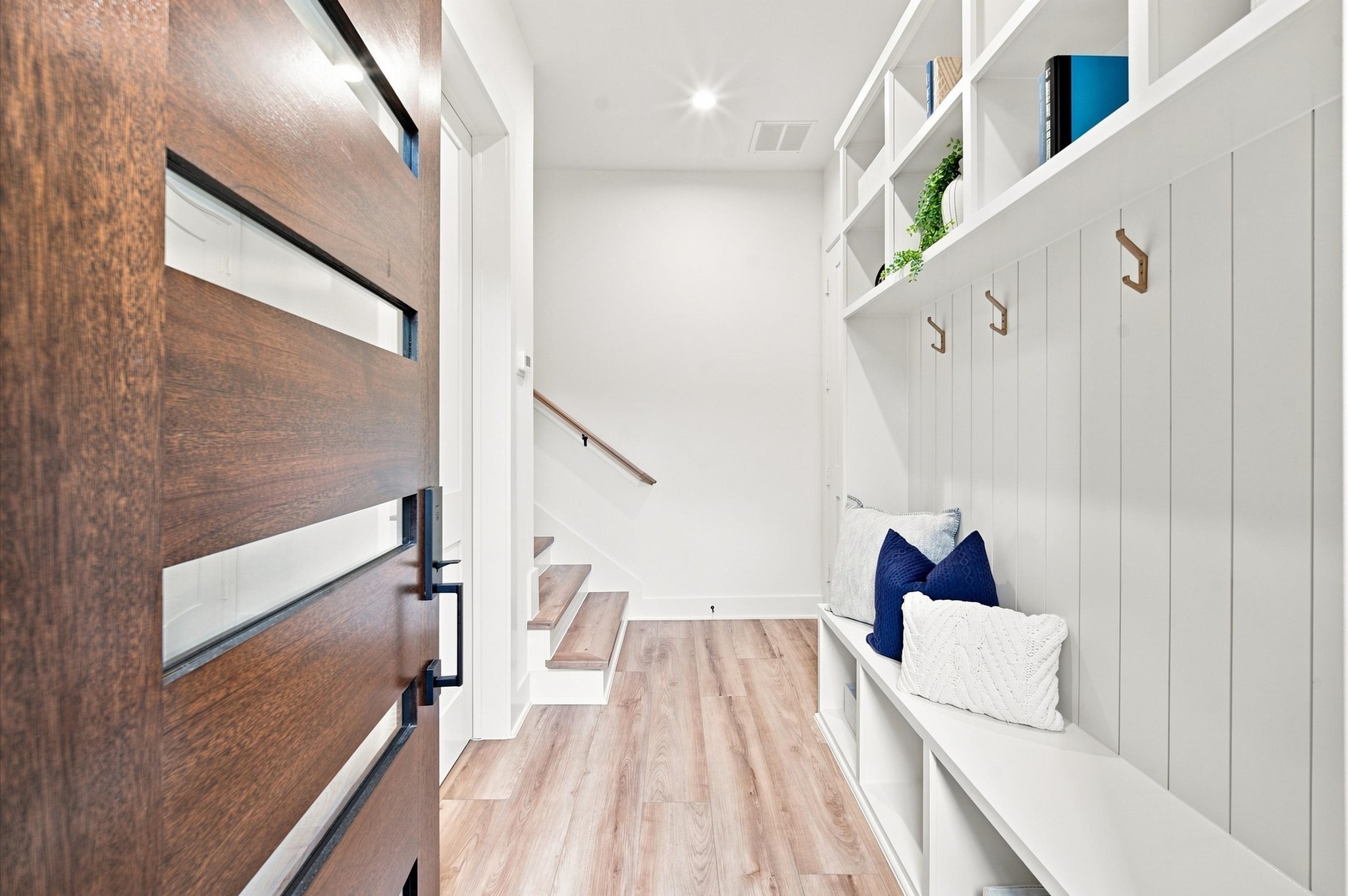 Mudroom with coat hangers upon entry