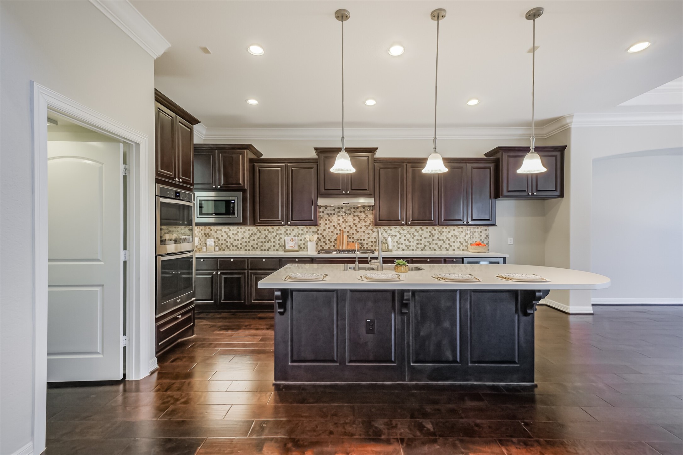 Chefs Dream! Expansive island kitchen featuring breakfast bar and pendant lamps.