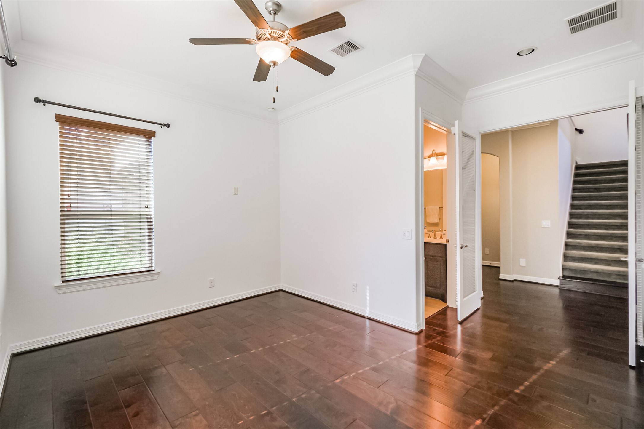 Versatile study/ secondary bedroom on first floor featuring French glass doors and a full bathroom. Versatile study/ secondary bedroom on first floor featuring French glass doors and a full bathroom.