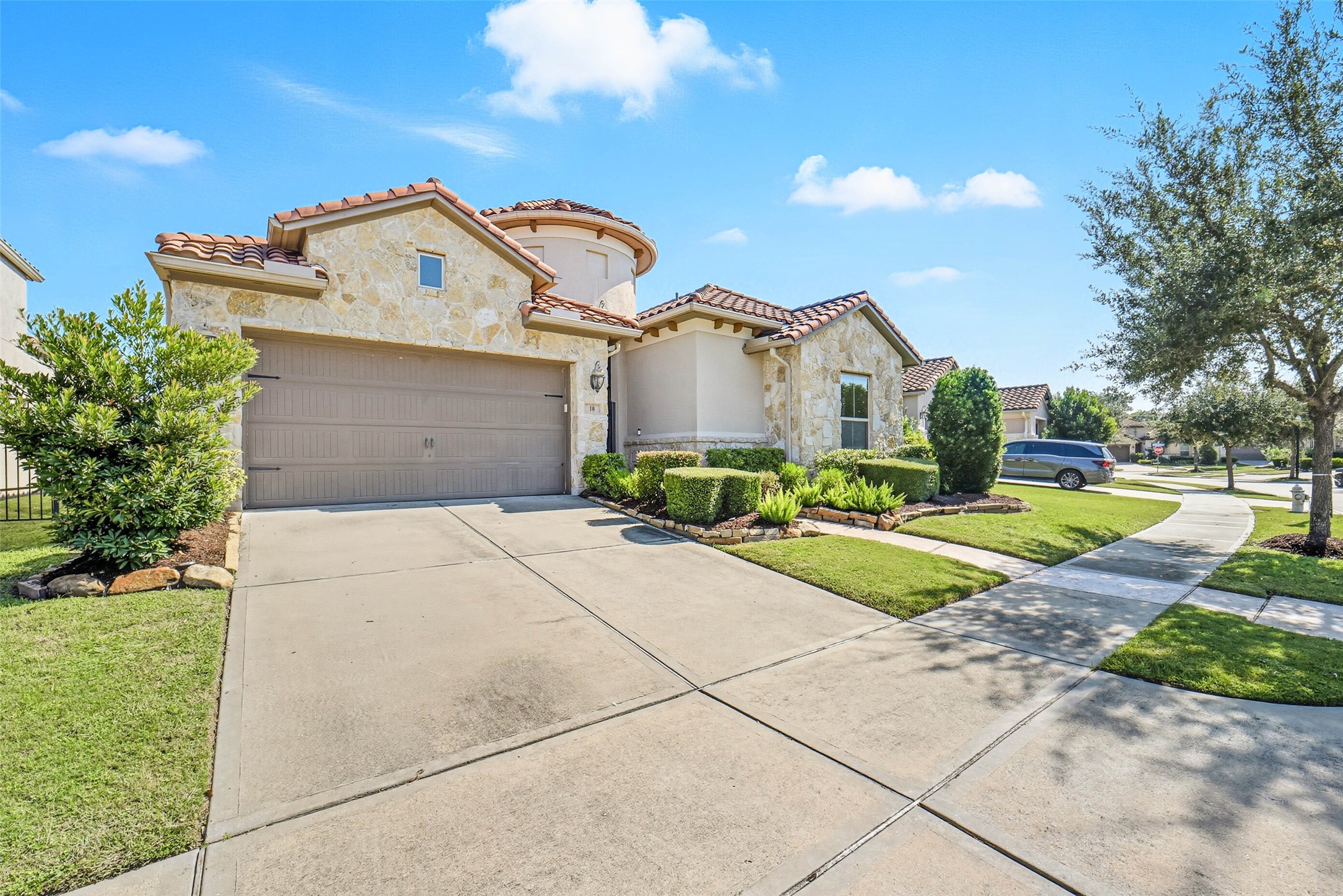 Double wide driveway that leads to a tandem 3 car garage. Double wide driveway that leads to a tandem 3 car garage.