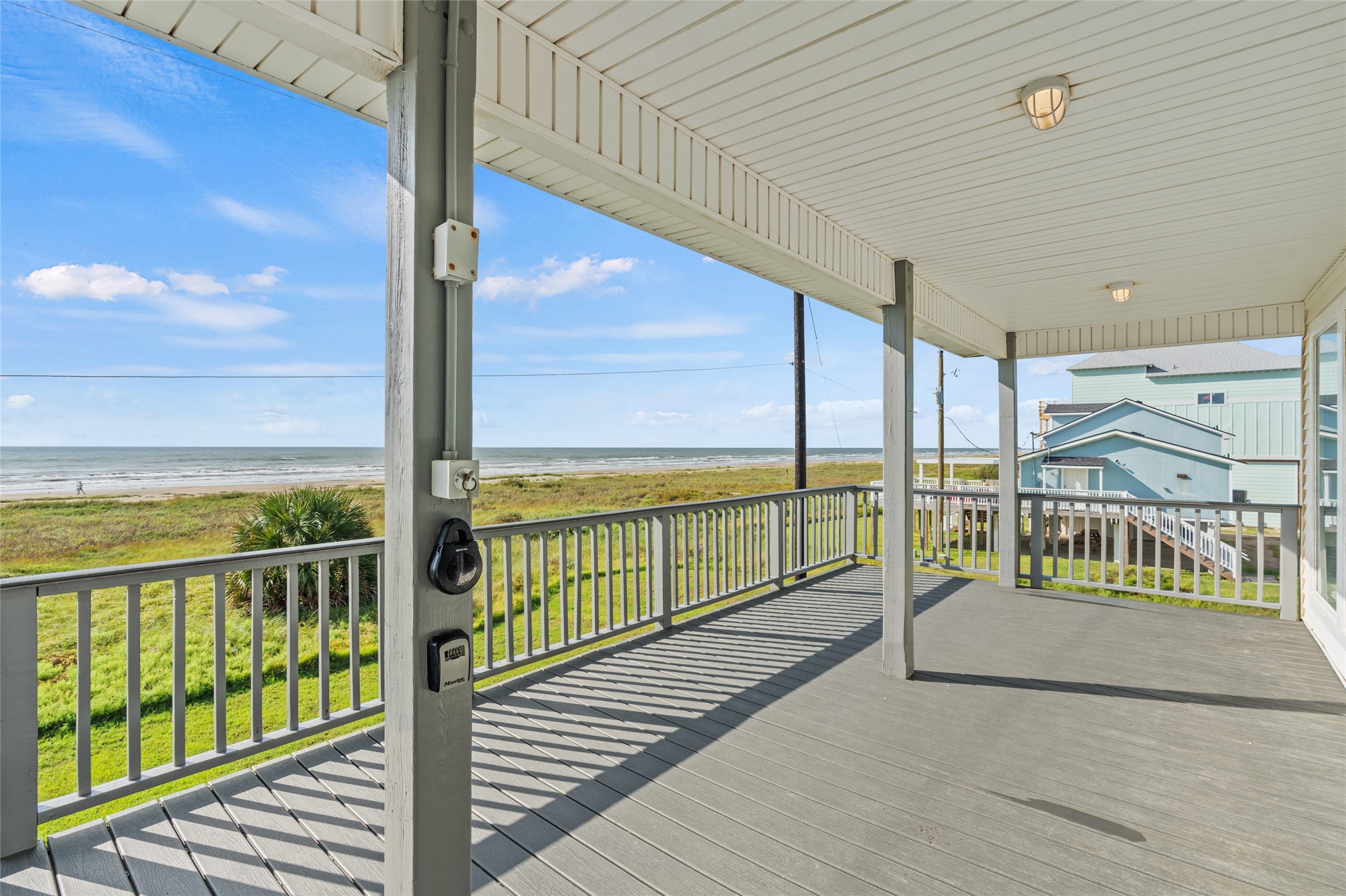 Expansive covered deck with stunning ocean views, perfect for relaxing and enjoying the coastal breeze.