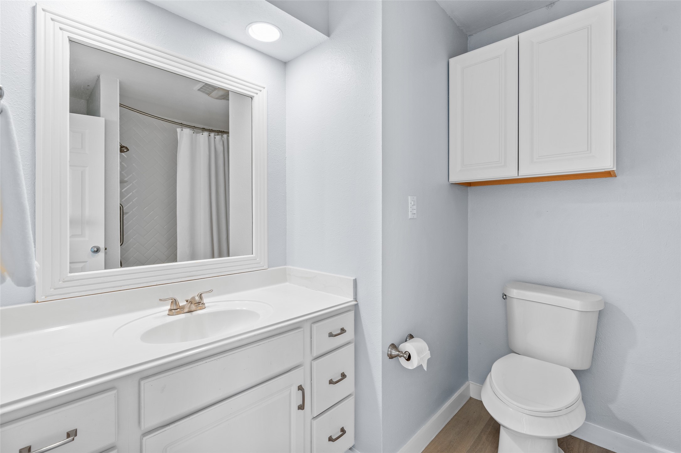 Bright and inviting bathroom with ample cabinet storage.
