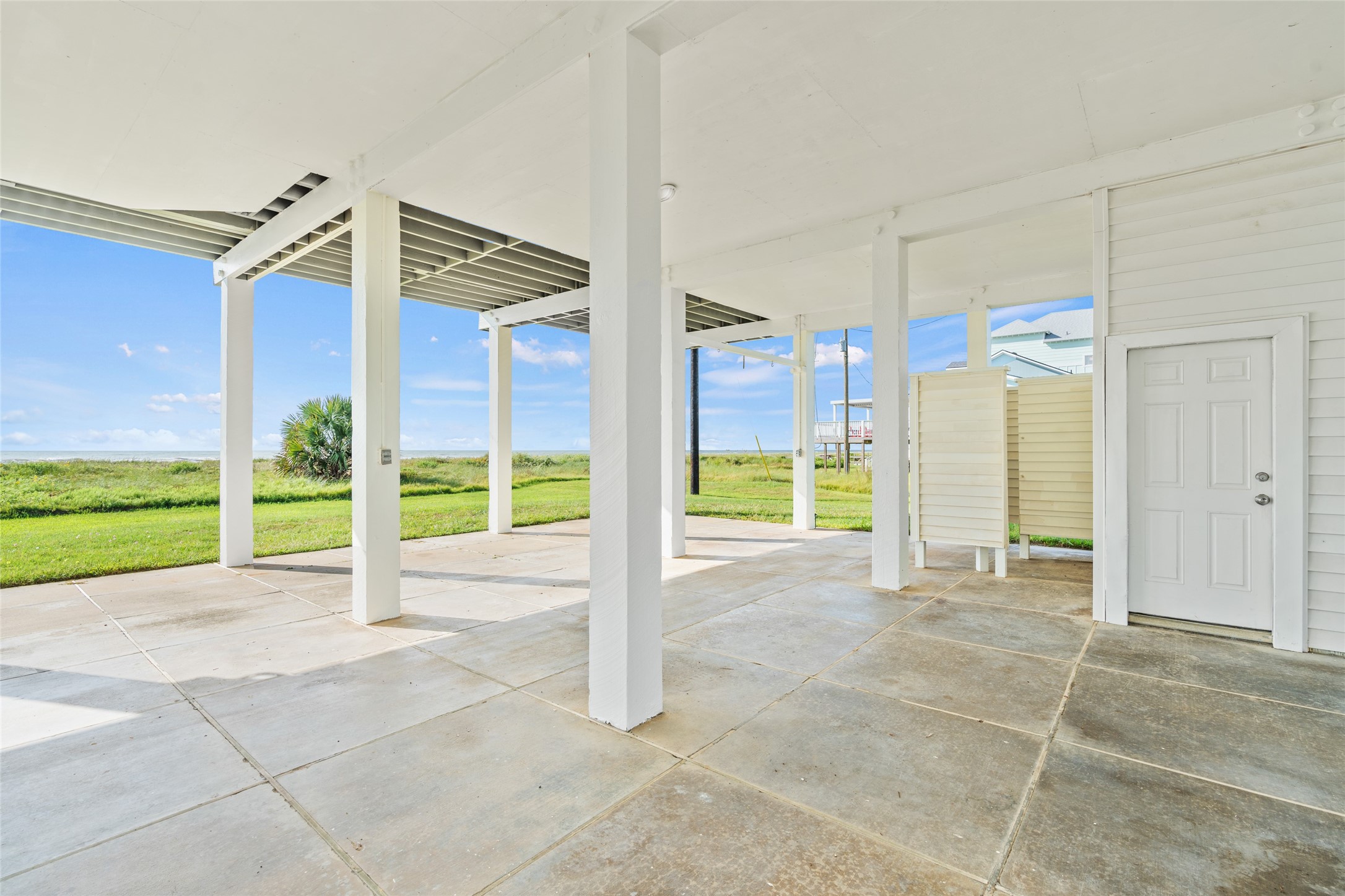 Spacious covered patio/parking area. Ideal for outdoor relaxation and gatherings.