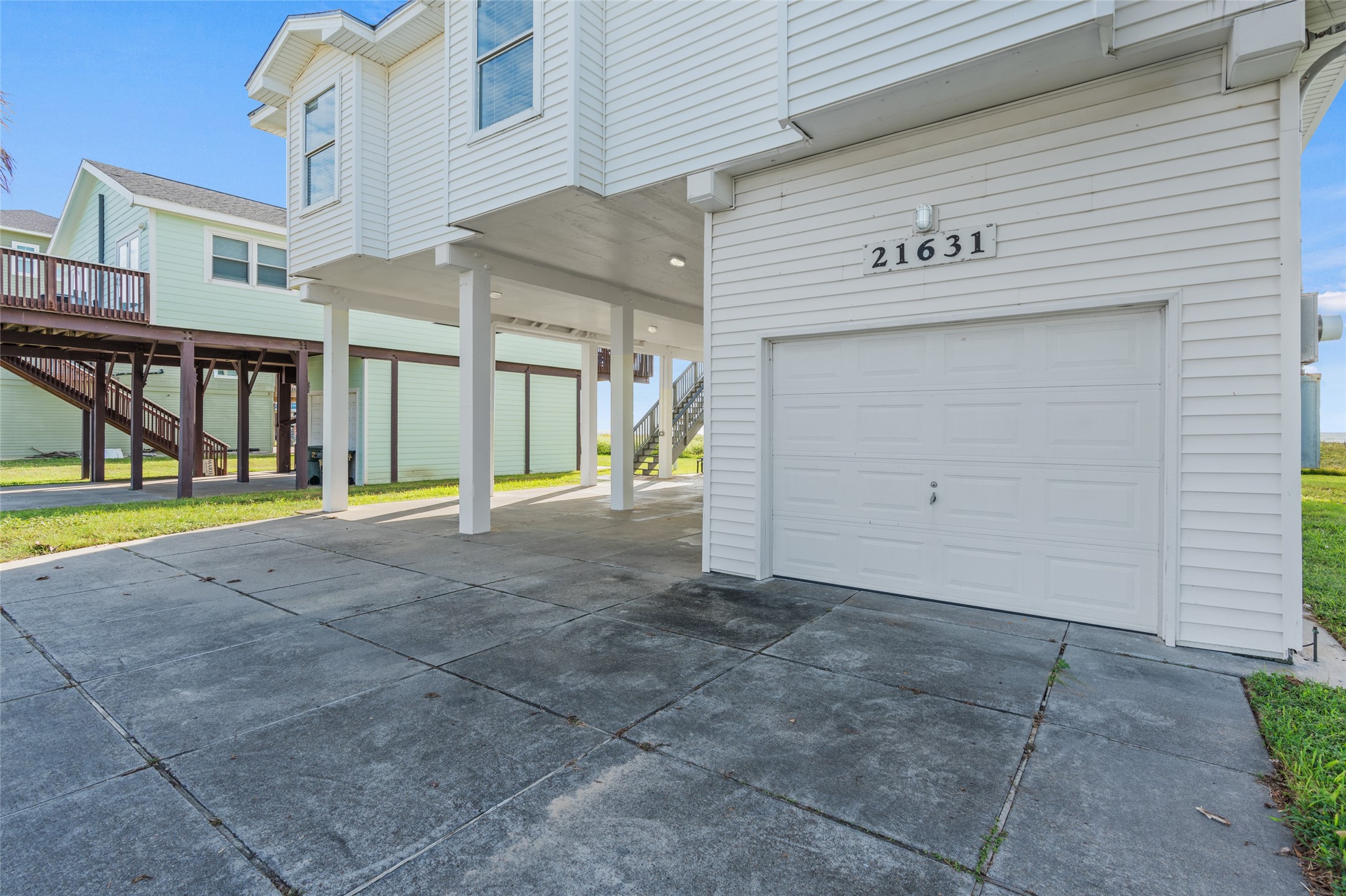 Coastal home with spacious covered parking and a convenient garage, perfect for beach life.