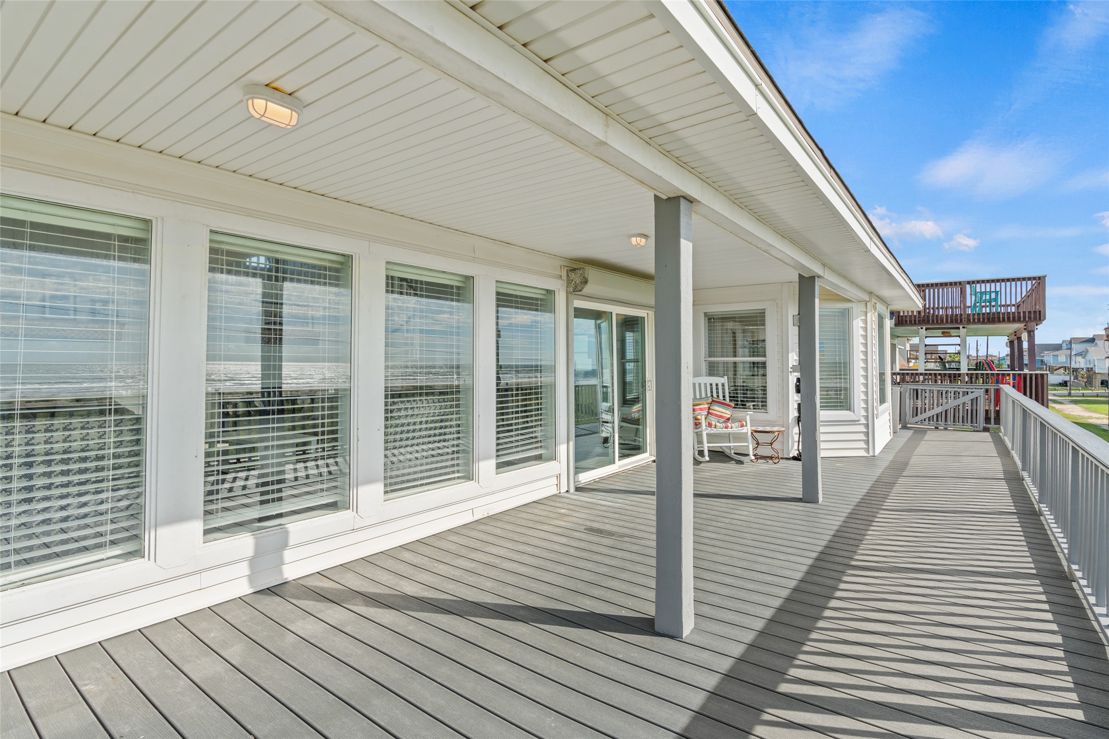 Porch with elegant railings and ample natural light, perfect for relaxing and enjoying outdoor views.