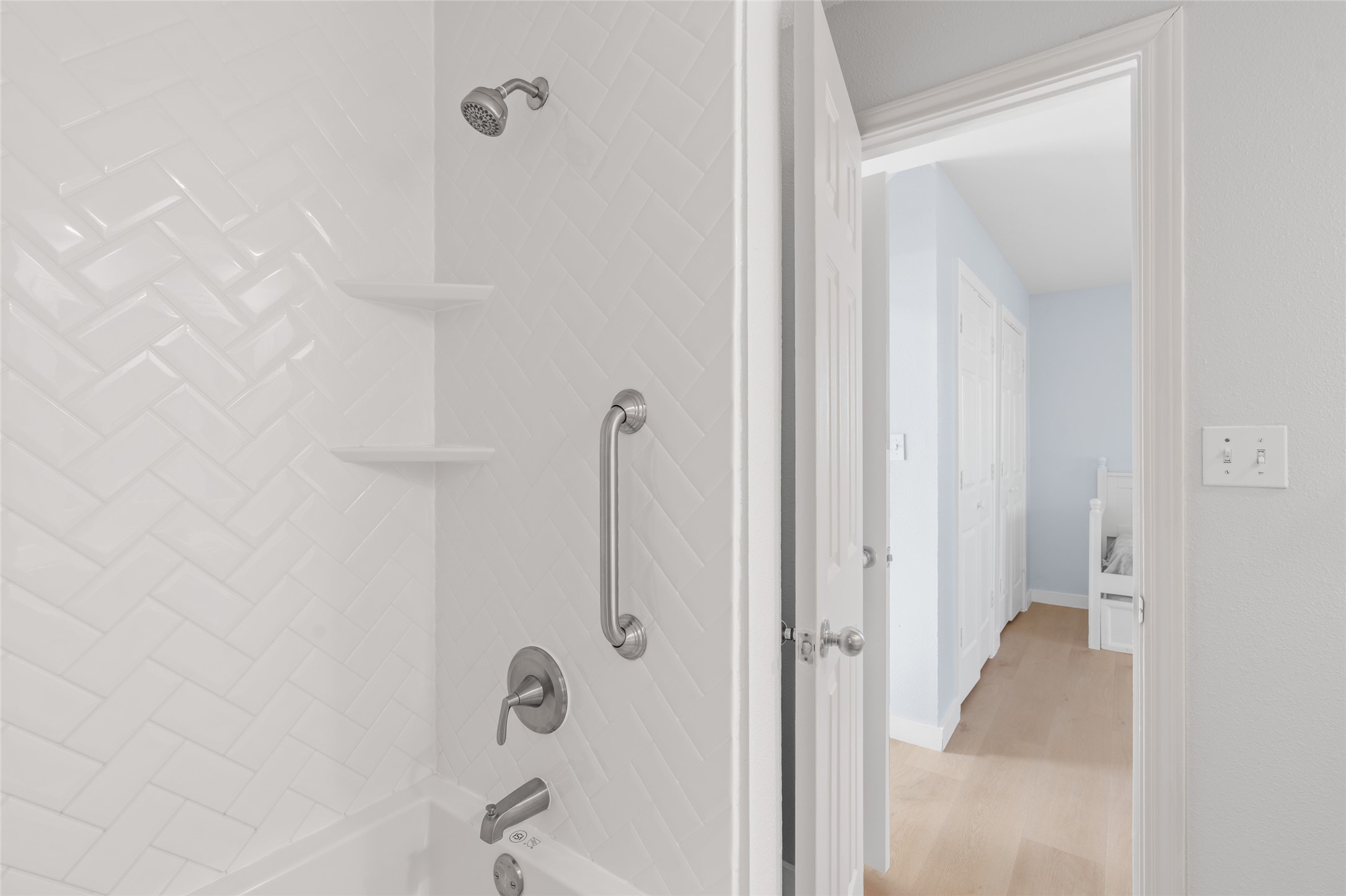 Other bathroom located adjacent to the hallway.
