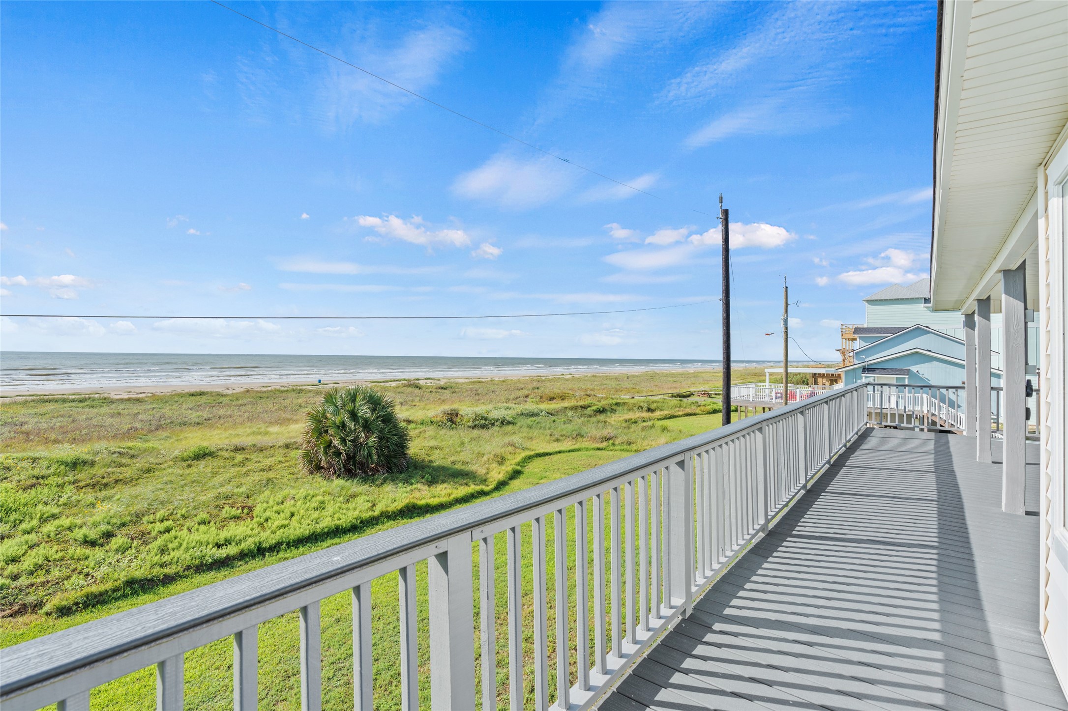Expansive balcony allows for enjoying coastal living.