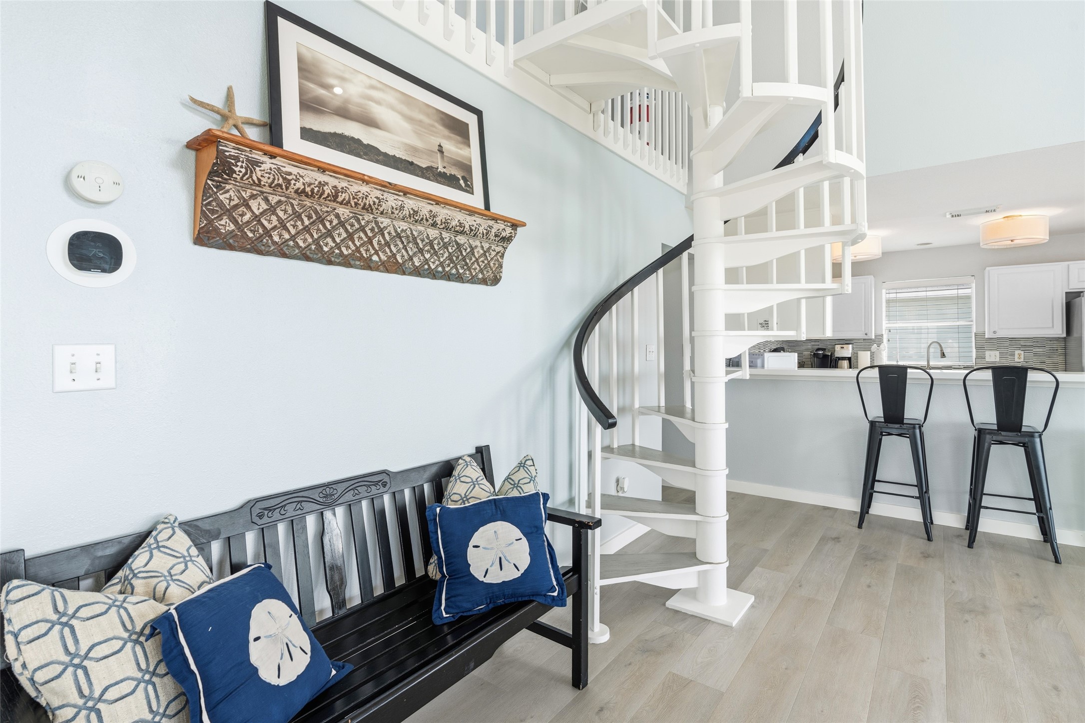 Charming living area shows the spiral staircase leading to the extra living area.