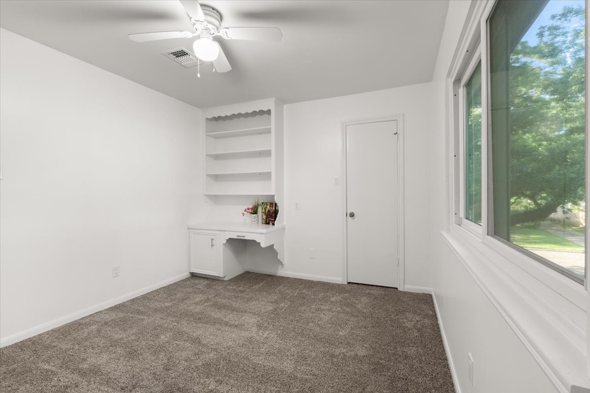Bedroom 3 features a built-in desk, vibrant mural,
new carpet, and fresh paint.
