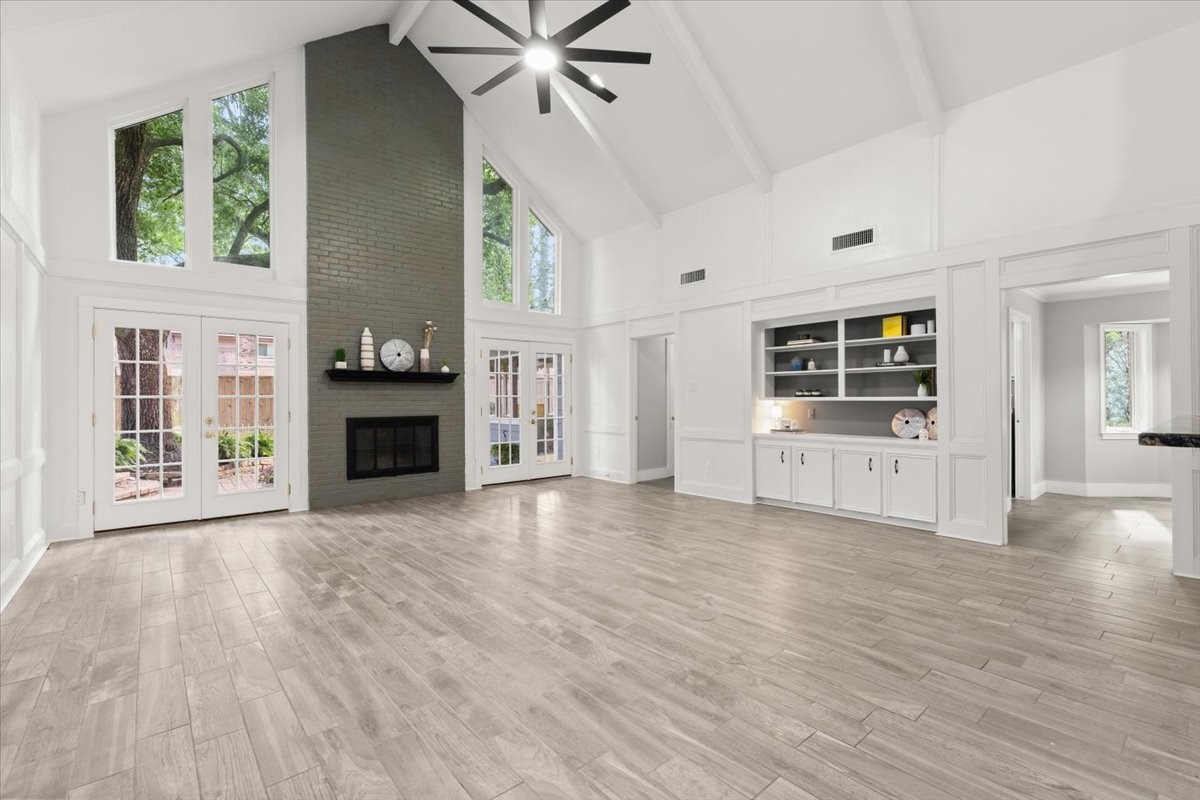 Step into an expansive living area with soaring
ceilings, a stylish bar, and stunning backyard views
through elegant French doors.