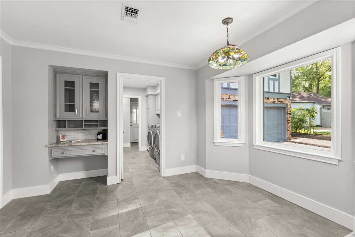 Spacious breakfast room with a built-in desk and
charming view.
