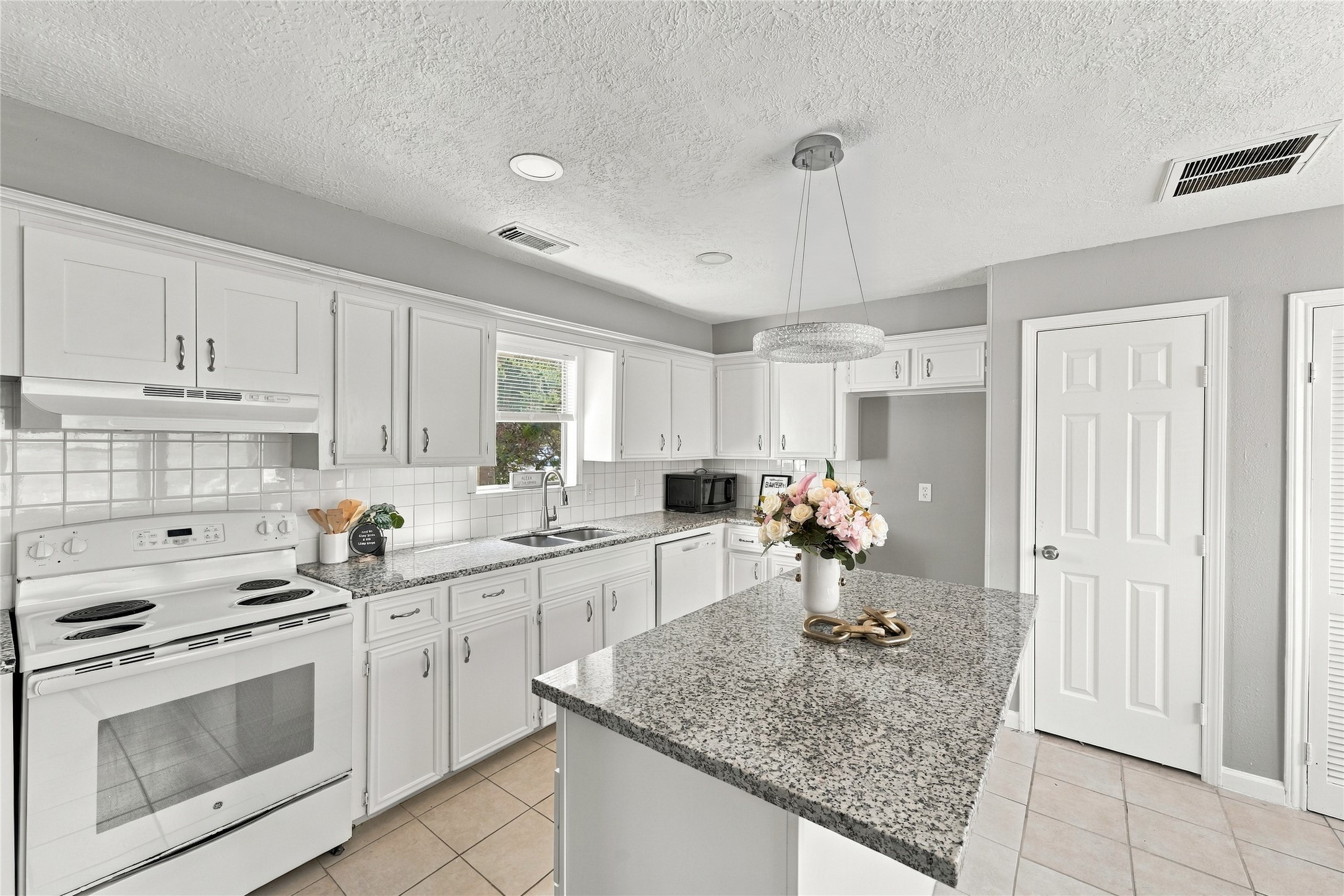 Kitchen featuring modern cabinetry, stainless steel appliances, and ample storage.