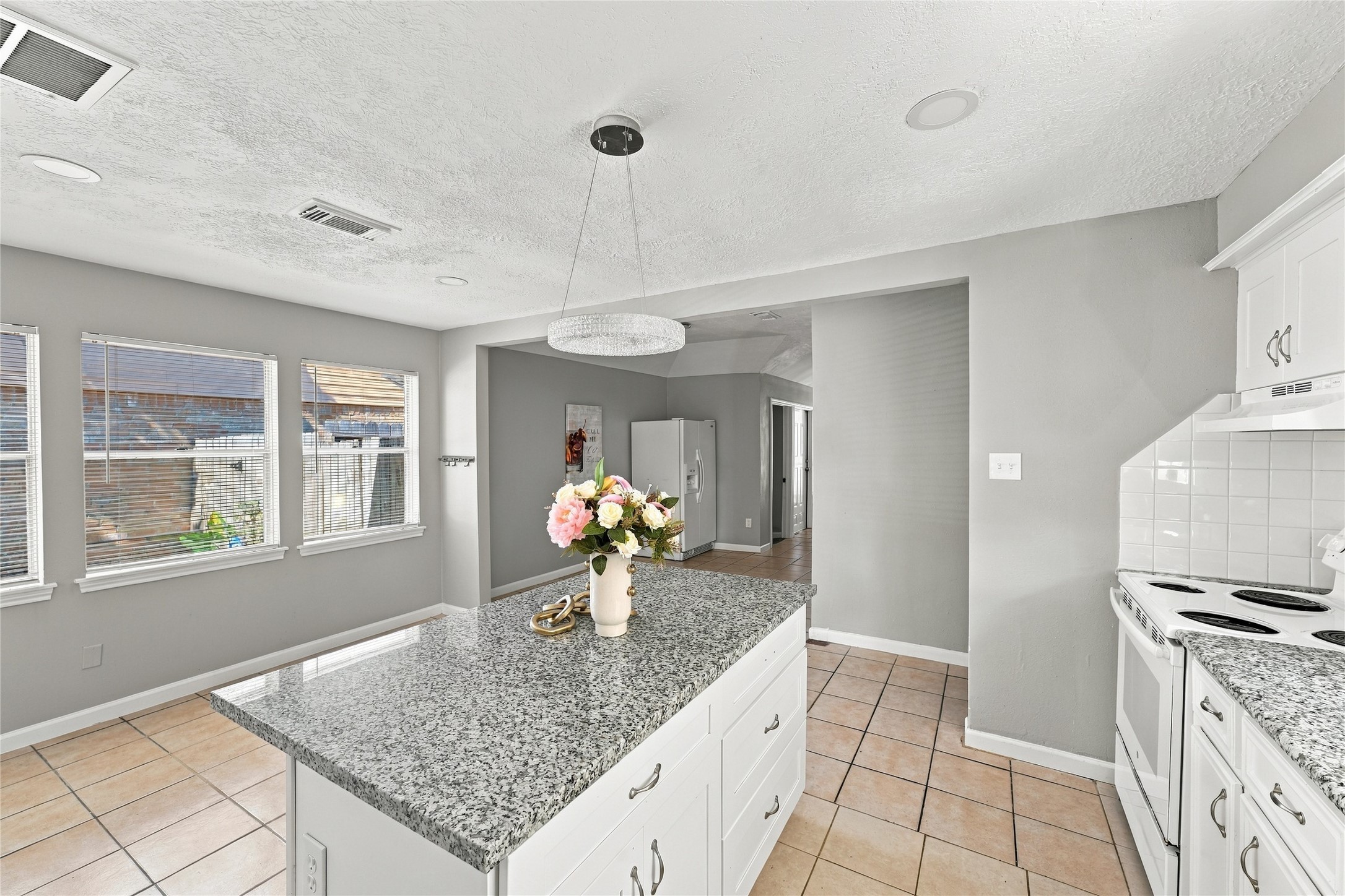 Open-concept kitchen with granite countertops and modern finishes