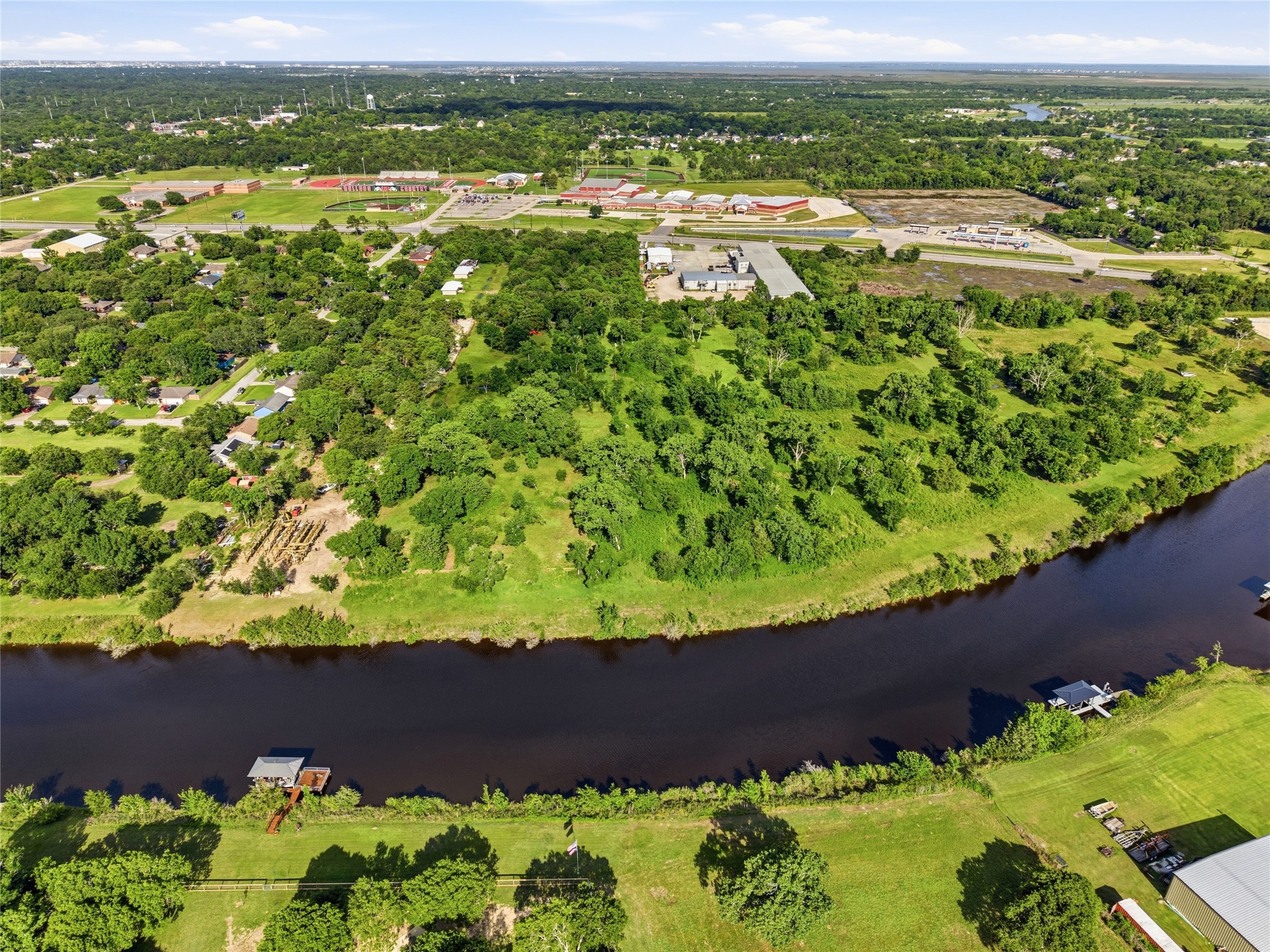 Aerial view of a lush, green landscape with a river running along the bottom.