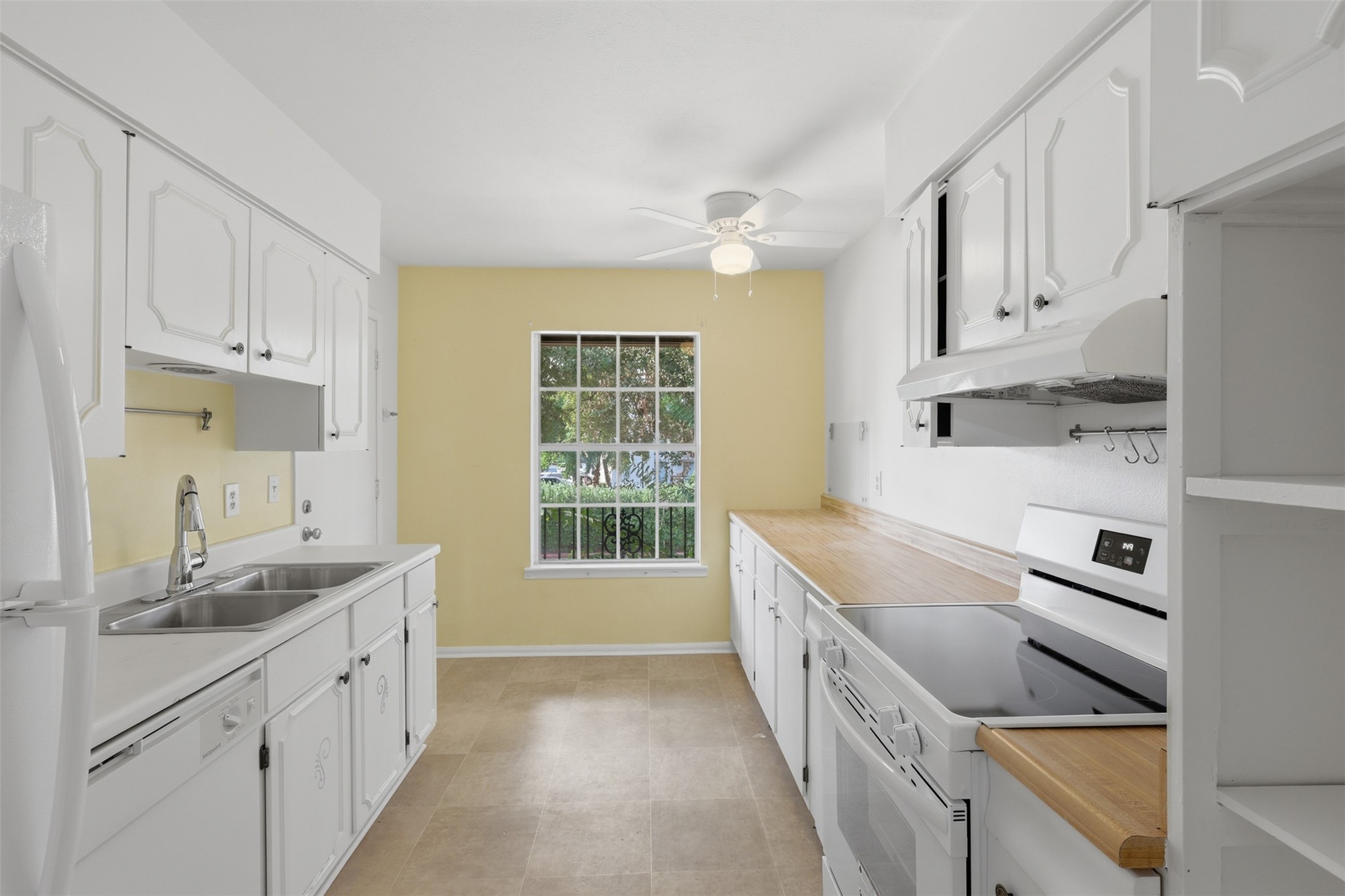 Bright and inviting kitchen with ample counter space, classic cabinetry, and a charming window view perfect for culinary creativity. Bright and inviting kitchen with ample counter space, classic cabinetry, and a charming window view perfect for culinary creativity.