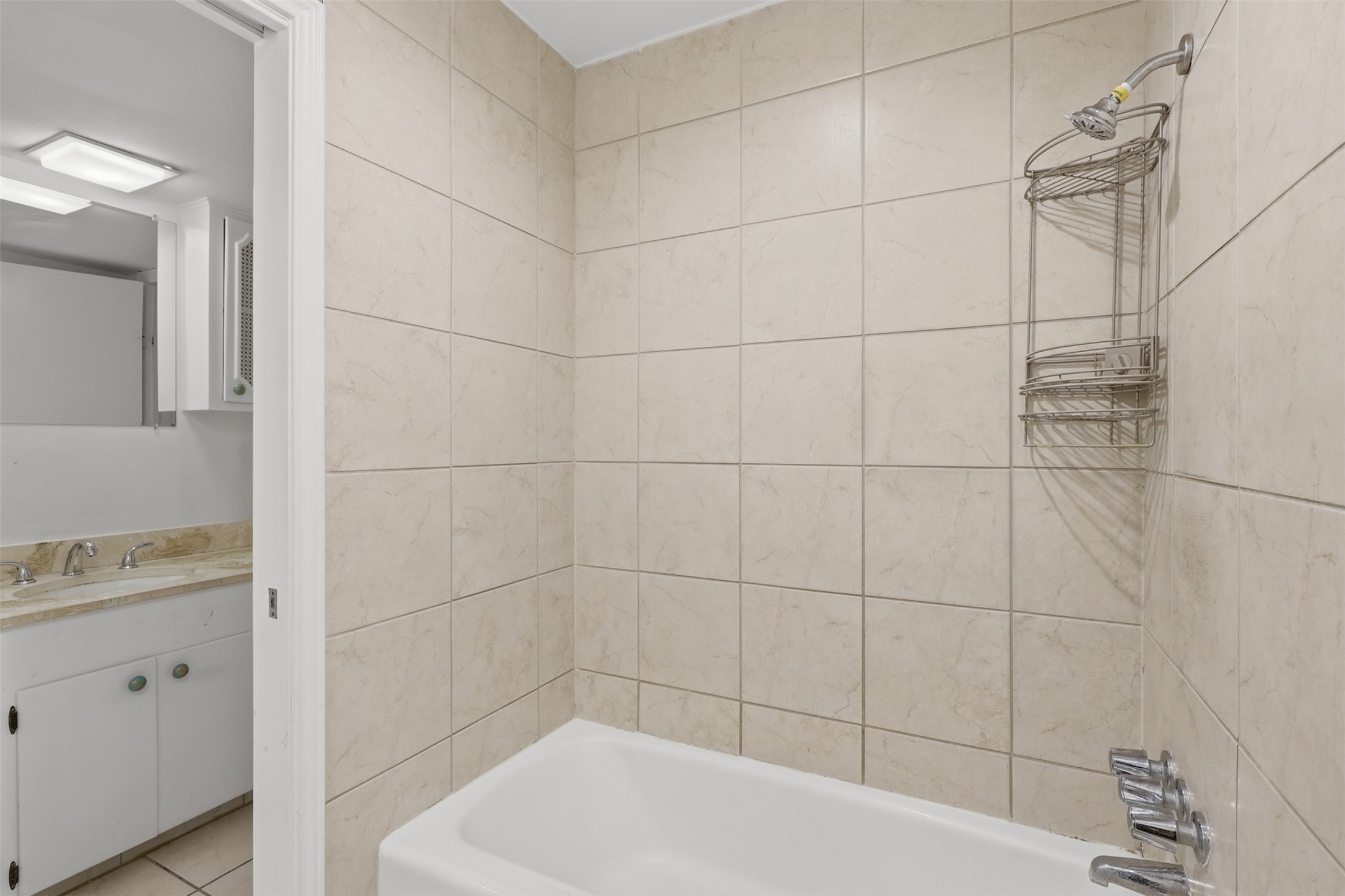 Indulge in the elegance of this primary bathroom, featuring sleek tile work and a modern shower-bathtub combo, all complemented by a sophisticated vanity area. Indulge in the elegance of this primary bathroom, featuring sleek tile work and a modern shower-bathtub combo, all complemented by a sophisticated vanity area.