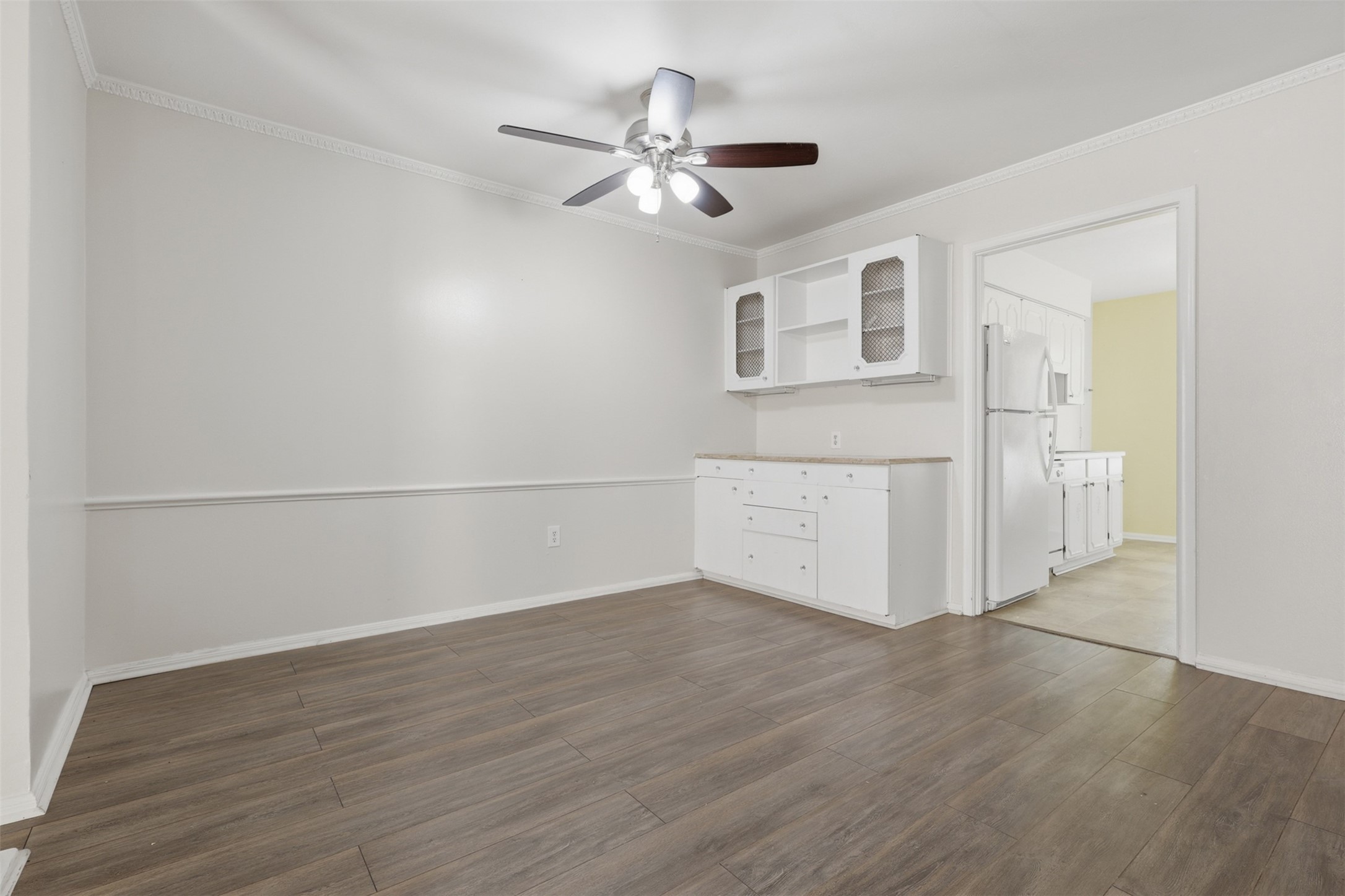 Discover a charming dining area featuring elegant wood flooring, abundant natural light, and built-in cabinetry for stylish storage and display.