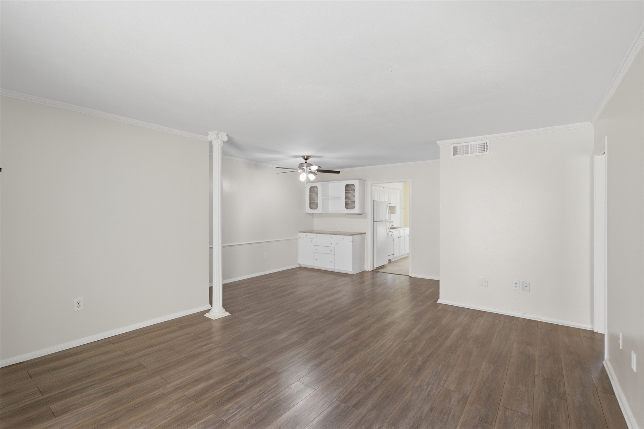 Experience effortless entertaining in this open, airy dining area with elegant hardwood floors and seamless flow to the kitchen, perfect for gatherings.