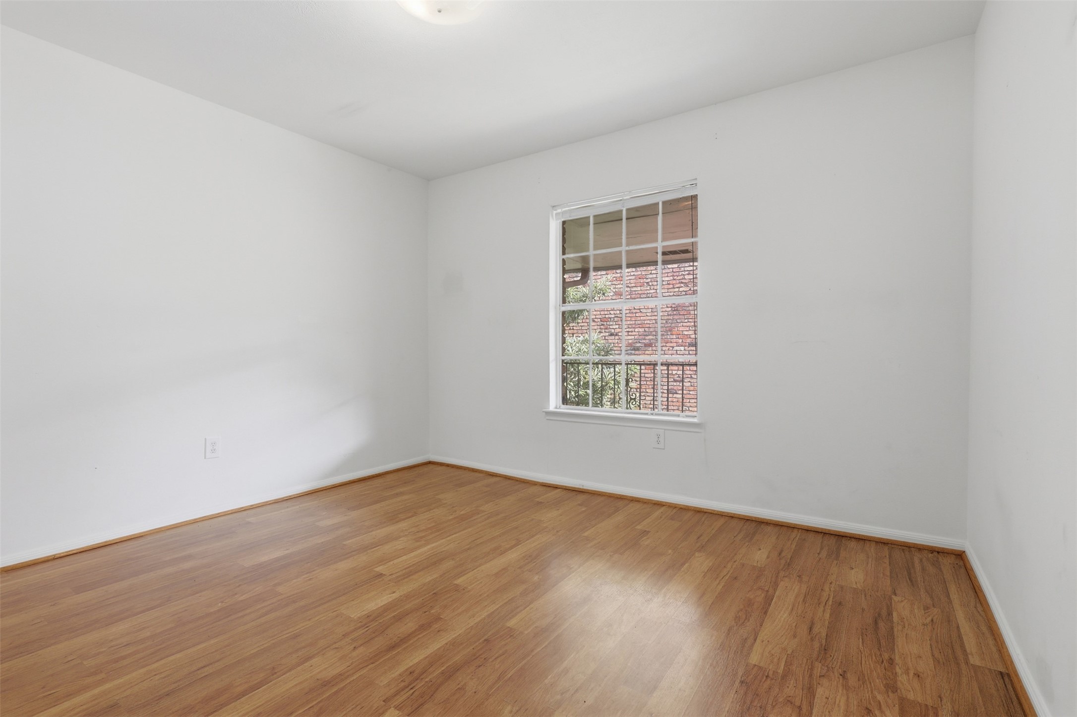 Bright and inviting, this second bedroom offers a serene space with natural light streaming through a large window, perfectly complementing the warmth of its hardwood floors. Bright and inviting, this second bedroom offers a serene space with natural light streaming through a large window, perfectly complementing the warmth of its hardwood floors.