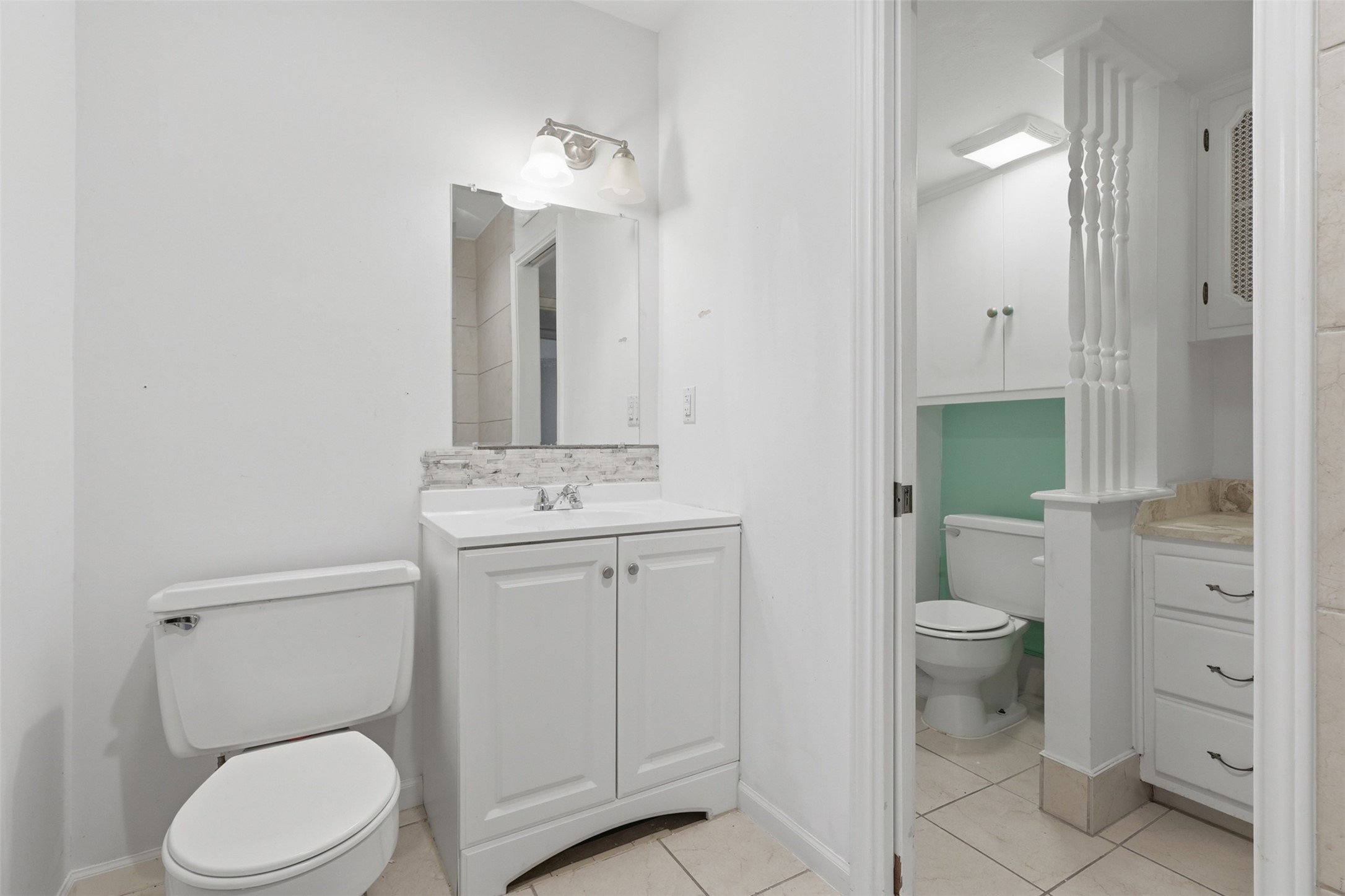 Experience refined elegance in this primary bathroom, featuring a sleek vanity, ample storage, and a clean, modern design.