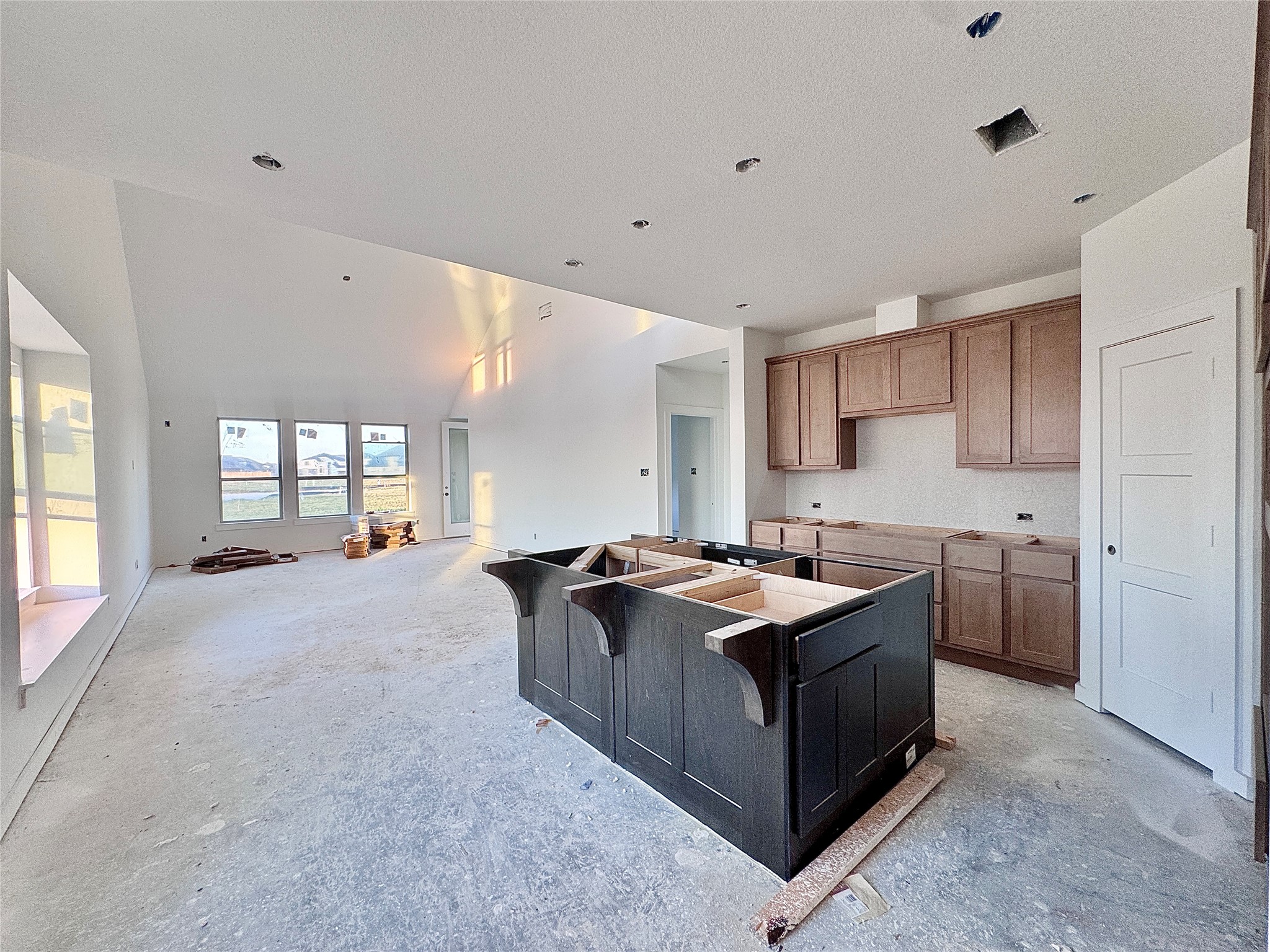 Once you make your way down the entry hall, through the arch, picture a massive island to your right! The kitchen opens up to the dining and family room.