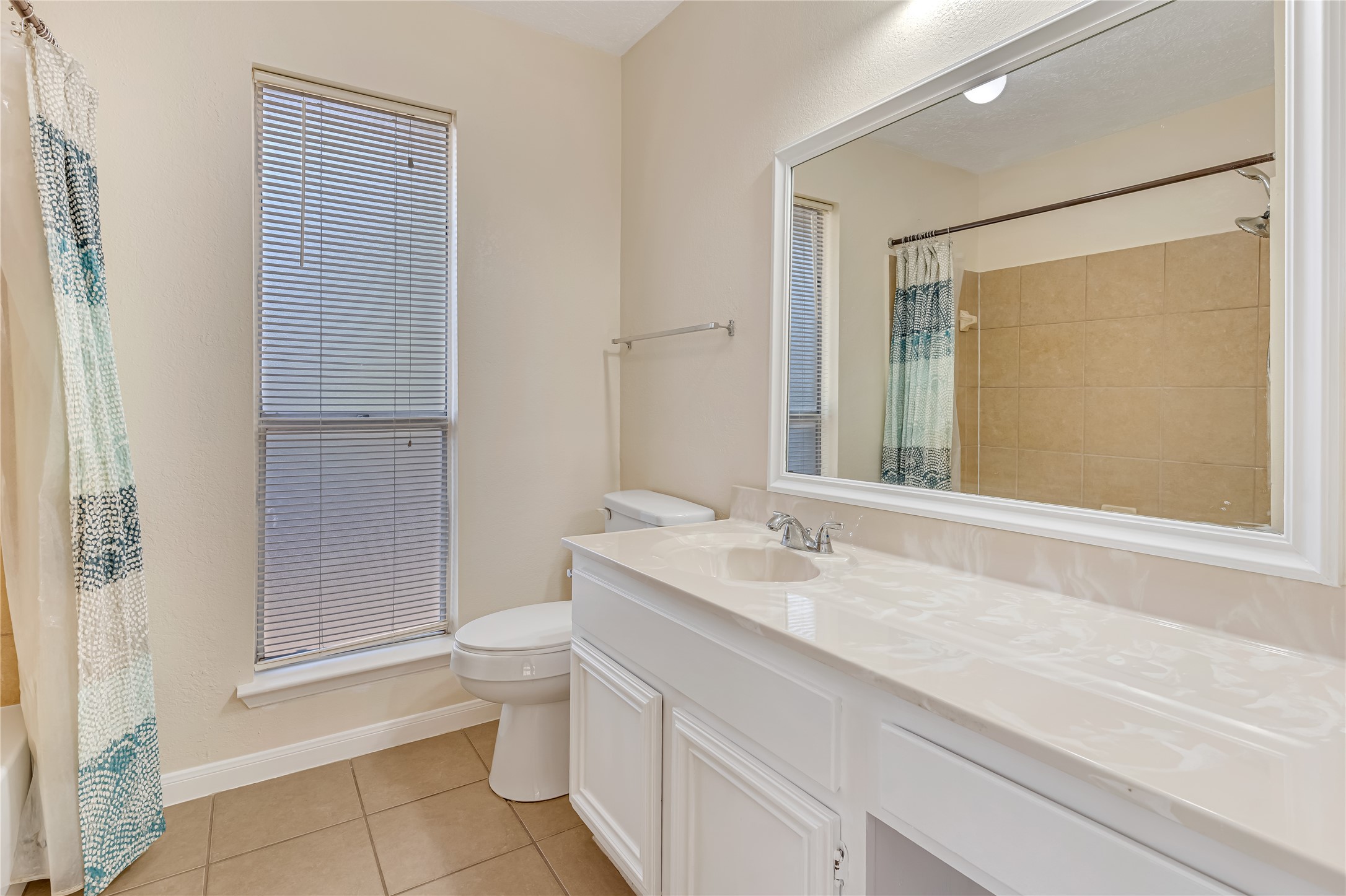 The bright and inviting primary bathroom offers a refreshing space to start your day and unwind in the evening. Its light-filled atmosphere creates a clean, airy feel, adding to the comfort and appeal of the primary suite.