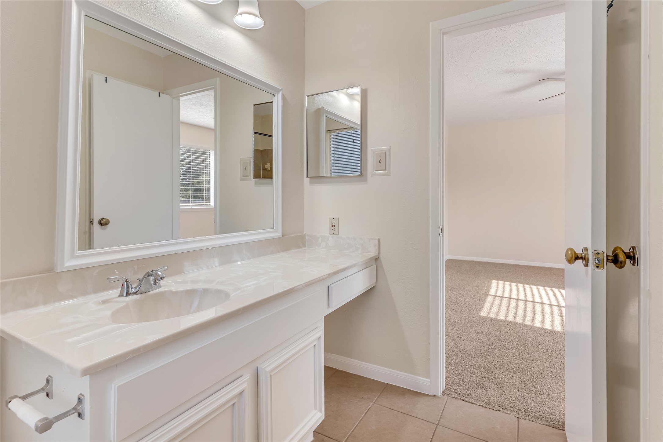 The bright and inviting primary bathroom offers a refreshing space to start your day and unwind in the evening. Its light-filled atmosphere creates a clean, airy feel, adding to the comfort and appeal of the primary suite.