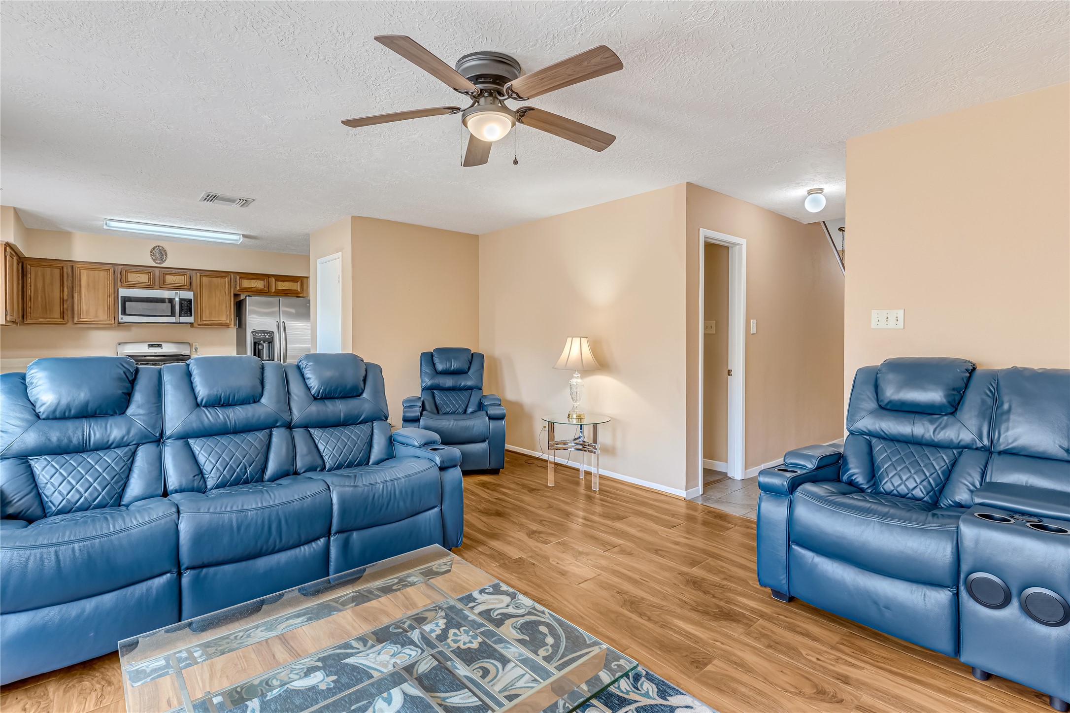 Welcome to a warm and inviting living room featuring a charming wood-burning fireplace, fresh paint, and updated flooring. This beautifully refreshed space offers the perfect setting for cozy evenings, family gatherings, and meaningful moments together. Imagine laughter filling the room, stories being shared by the fire, and memories being made that will last a lifetime. More than just a living space, this is where family connections grow and cherished memories begin.