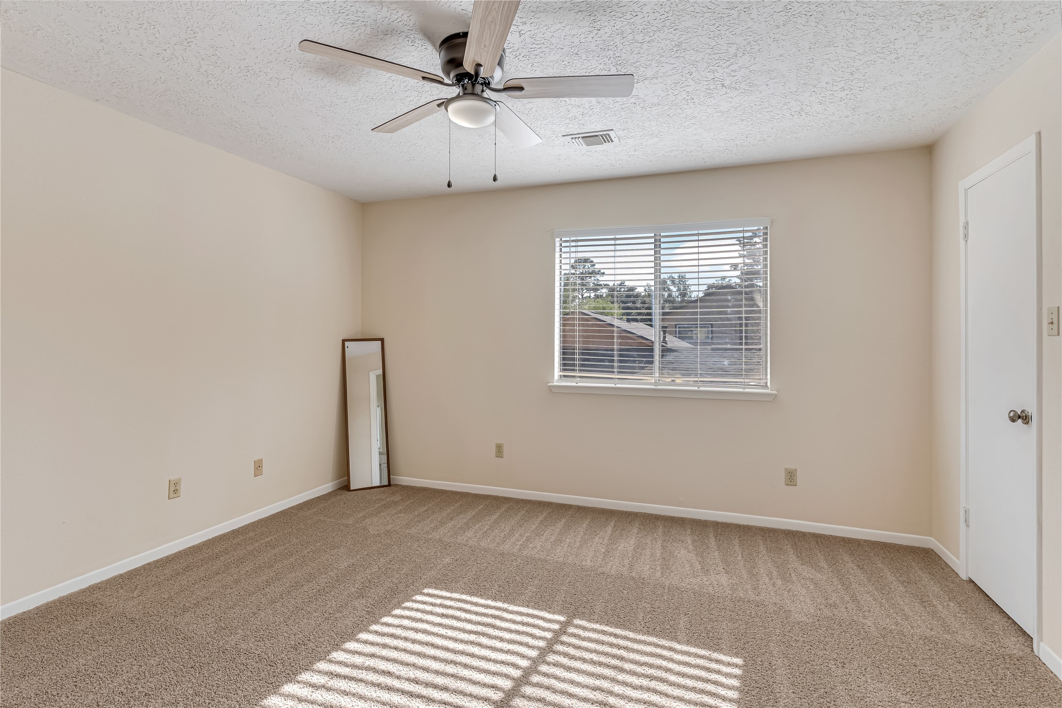 Retreat to the inviting primary bedroom, on the second floor, freshly updated with a crisp coat of paint, new carpet, and a stylish new ceiling fan with light fixture. These thoughtful updates create a fresh, comfortable atmosphere, offering the perfect place to unwind, relax, and recharge at the end of the day.