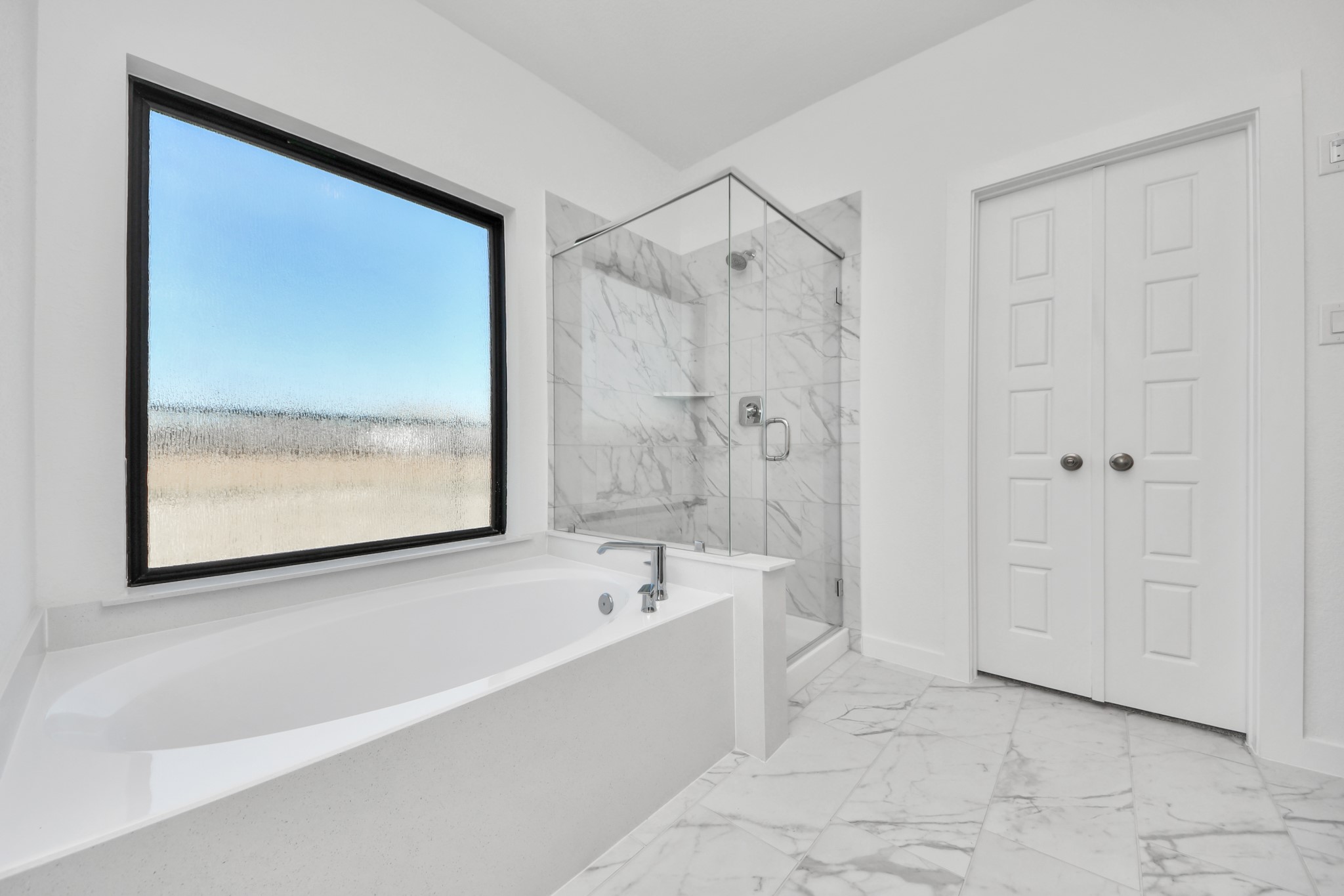 Indulge in a spa-like retreat within the confines of this primary bathroom. Delight in a spacious walk-in shower enveloped in stylish tile surround, unwind in a separate garden tub adorned with custom detailing.