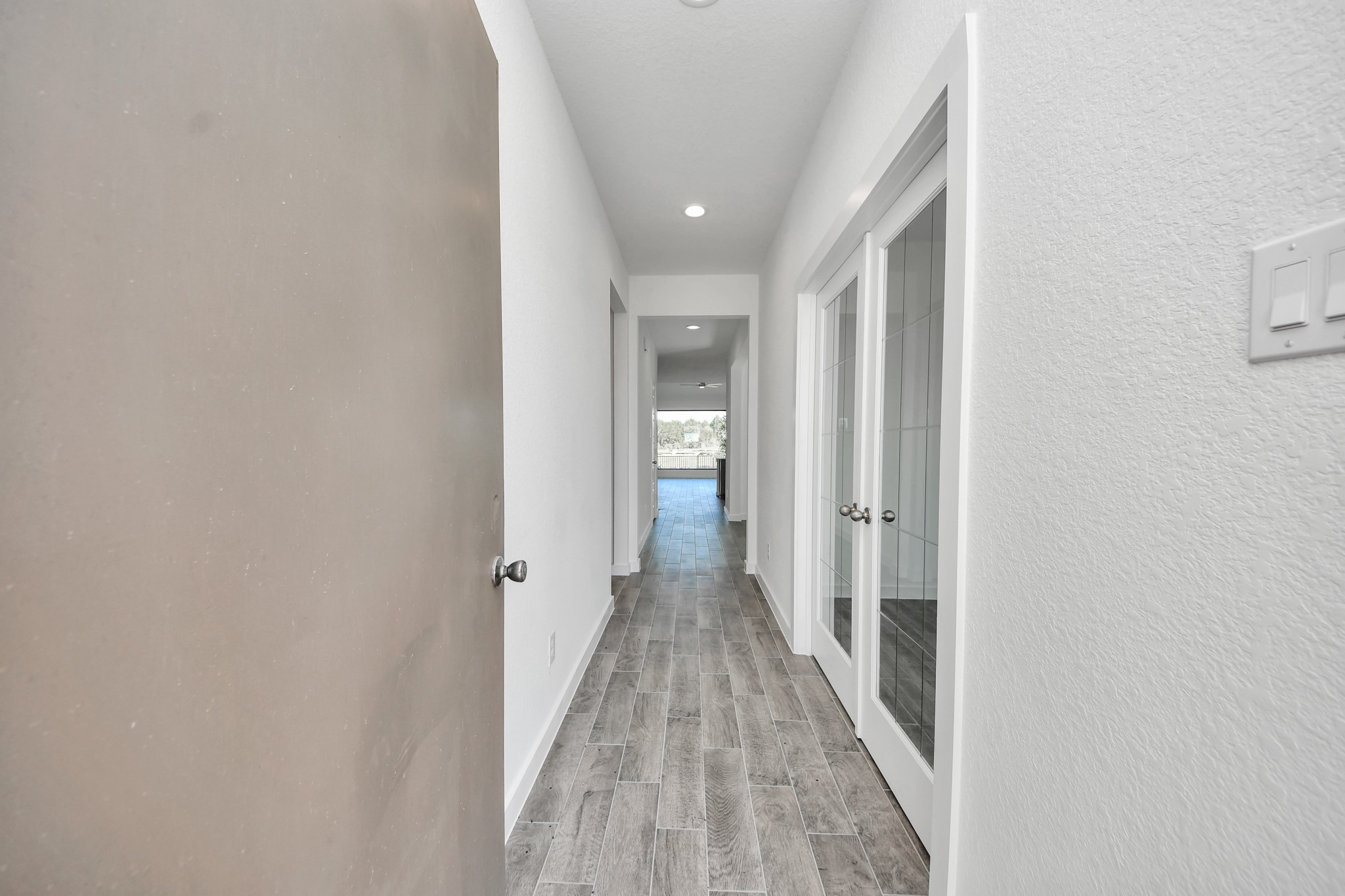 As you step into the threshold of this luxurious home, you'll soon be welcomed by an elegant glass door (to be installed). Inside, soaring ceilings amplify the spaciousness, while the refined wood-look tile flooring and oversized baseboards exude sophistication and charm.