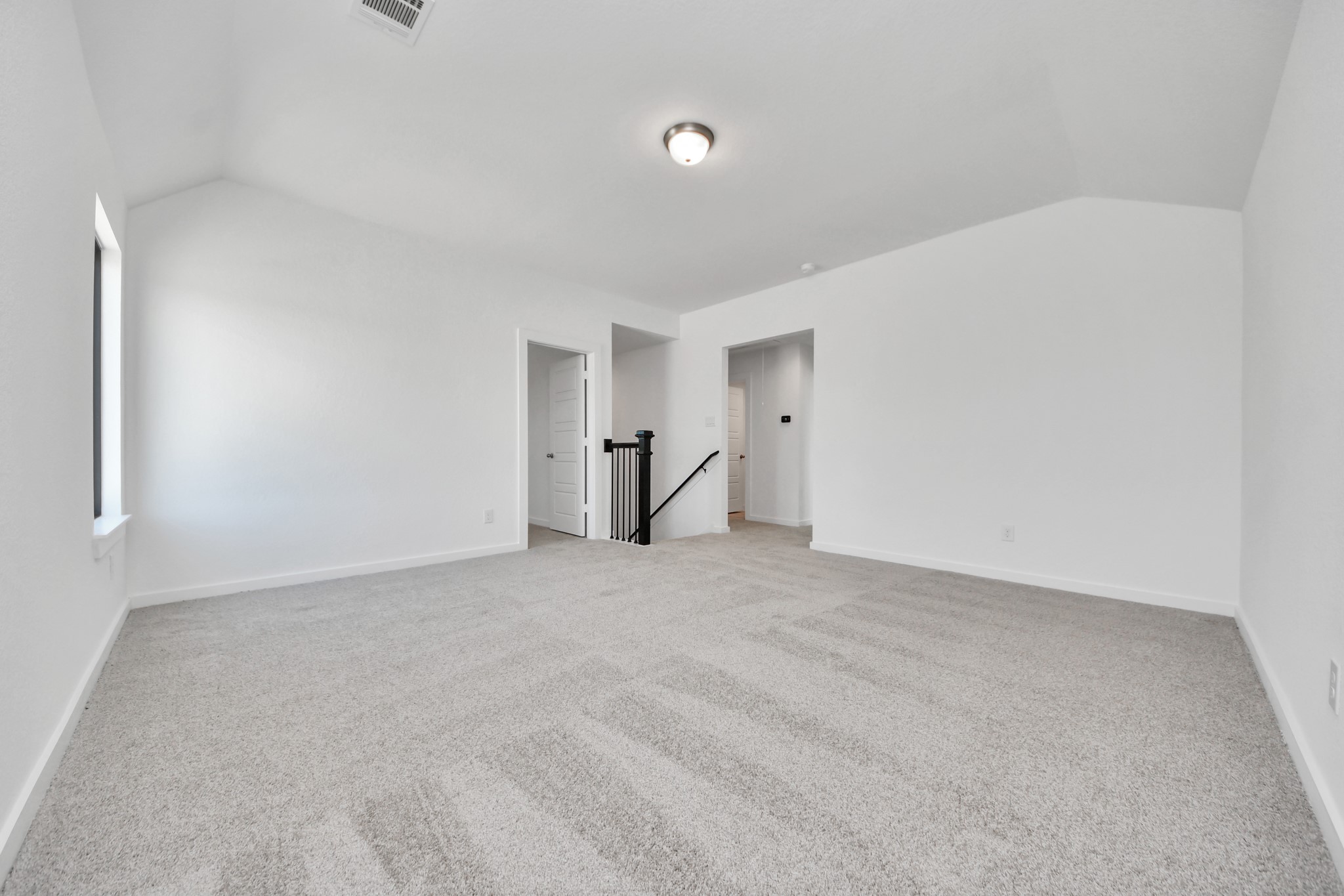Discover a haven of leisure in this fantastic game room! Whether you're seeking a casual hangout or an adult gaming retreat, this space has it all. Enjoy the luxurious feel of plush carpet underfoot, the expansive ambiance of high ceilings, custom paint that adds a touch of personality, and windows that flood the room with refreshing natural light.