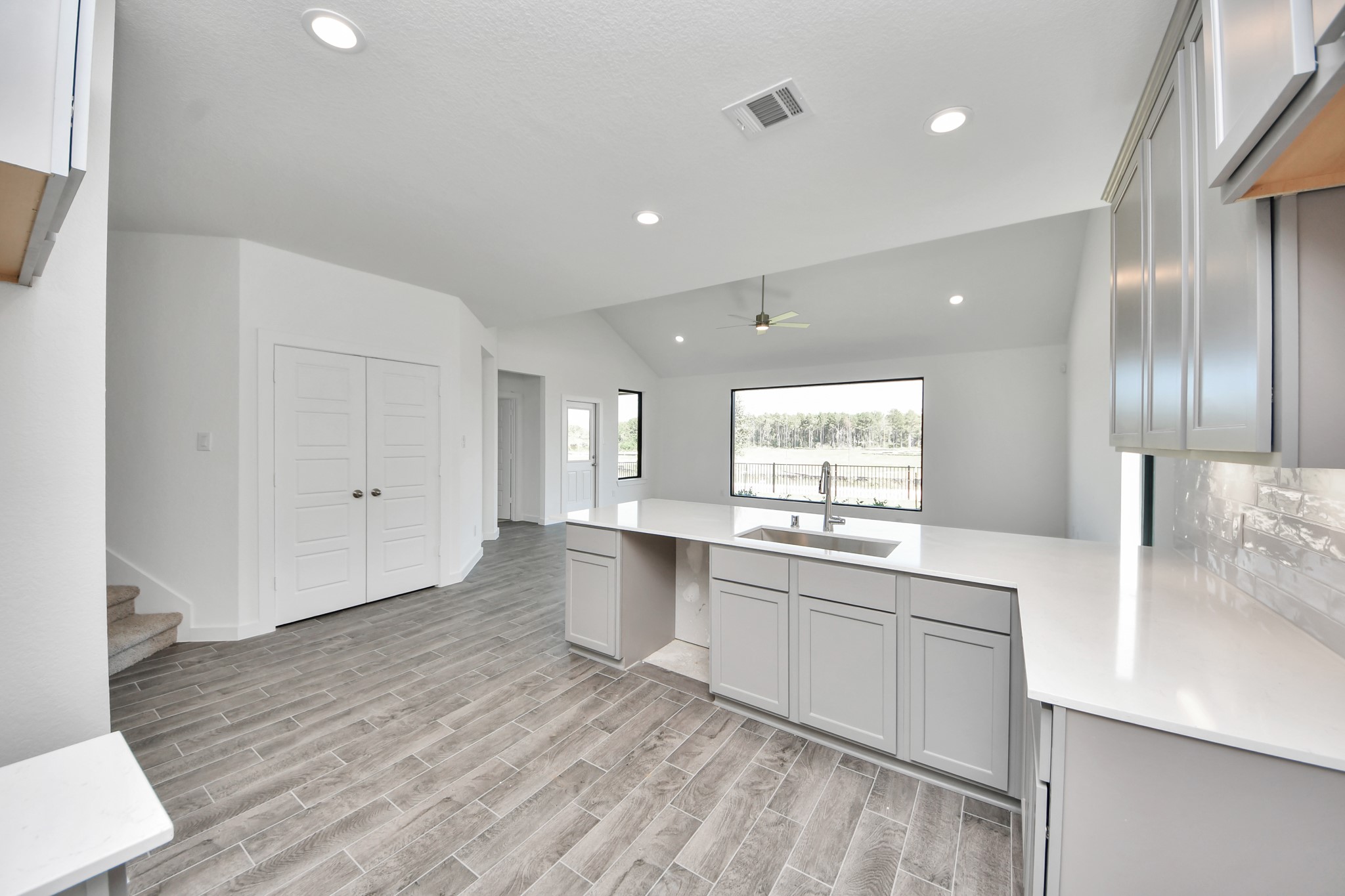 The open concept effortlessly connects the kitchen to the expansive family room, forming a perfect hub for gatherings. This seamless flow creates an inviting space where cooking and socializing come together harmoniously.