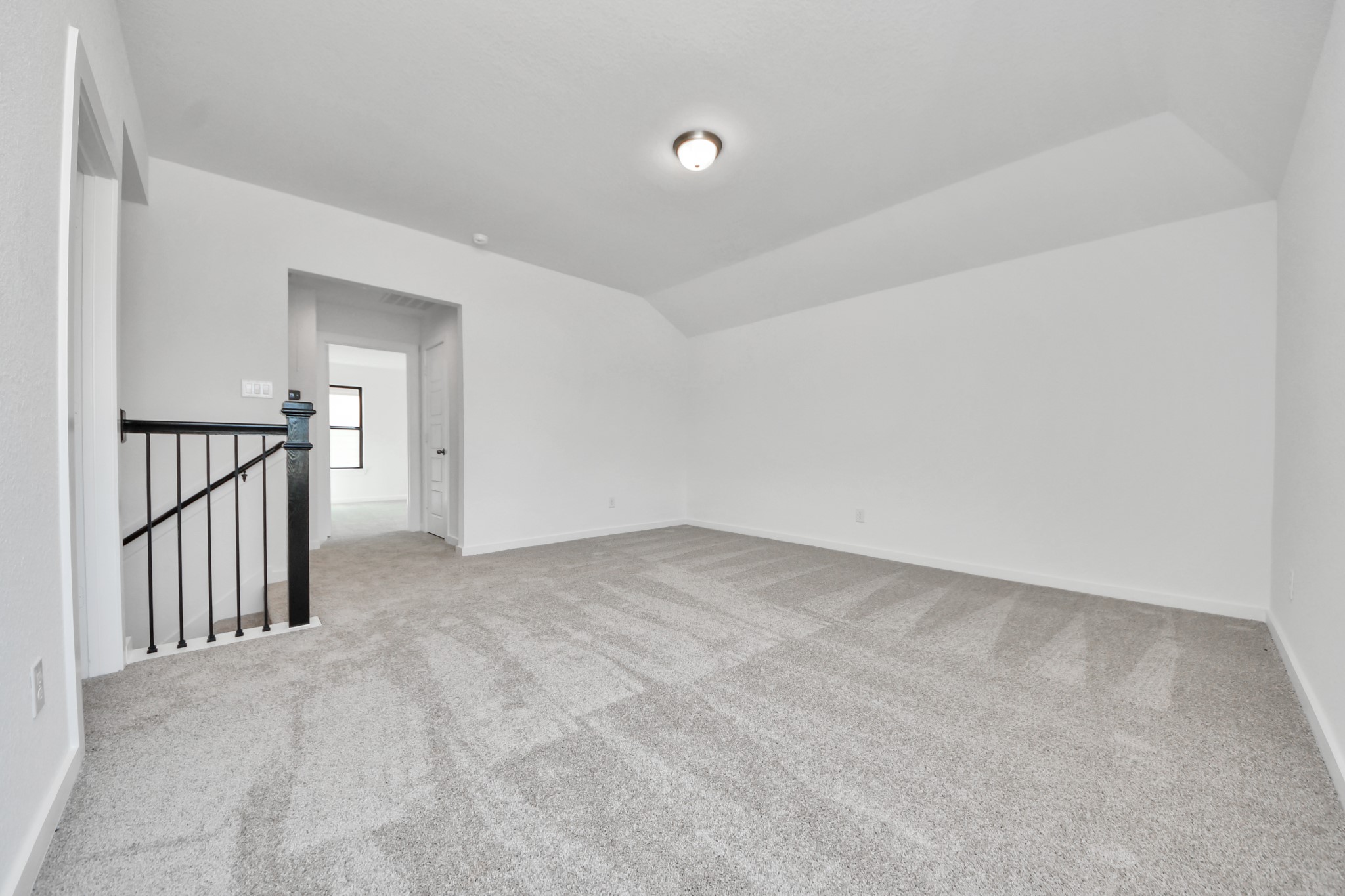 Come upstairs and enjoy a day of leisure in this fabulous game room! This is the perfect hangout spot or adult game room! Features plush carpet, high ceilings, custom paint and windows for plenty of natural light.