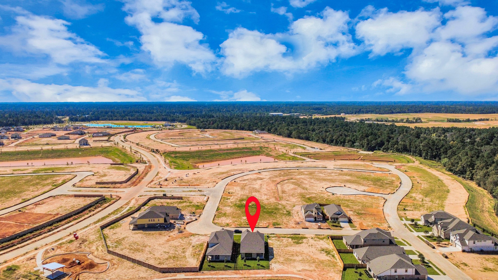 An aerial view of a spacious subdivision lot, highlighting a well-maintained yard and a fully fenced perimeter, offering both privacy and expansive outdoor space.