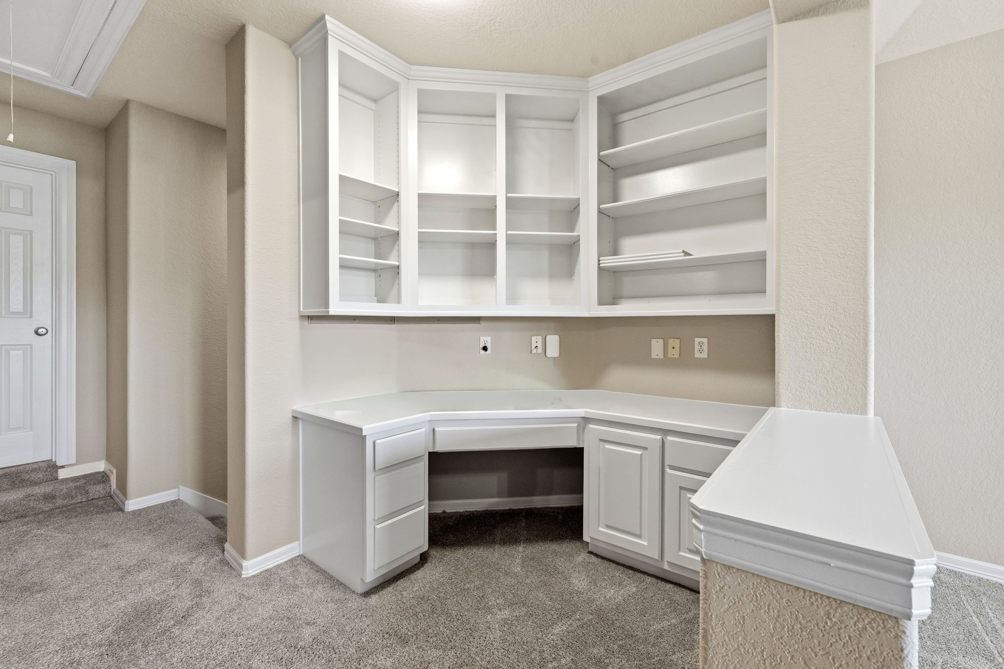 Bright and functional office nook upstairs with built-in shelving and cabinetry, perfect for organizing and productivity. Great for childrens homework station.