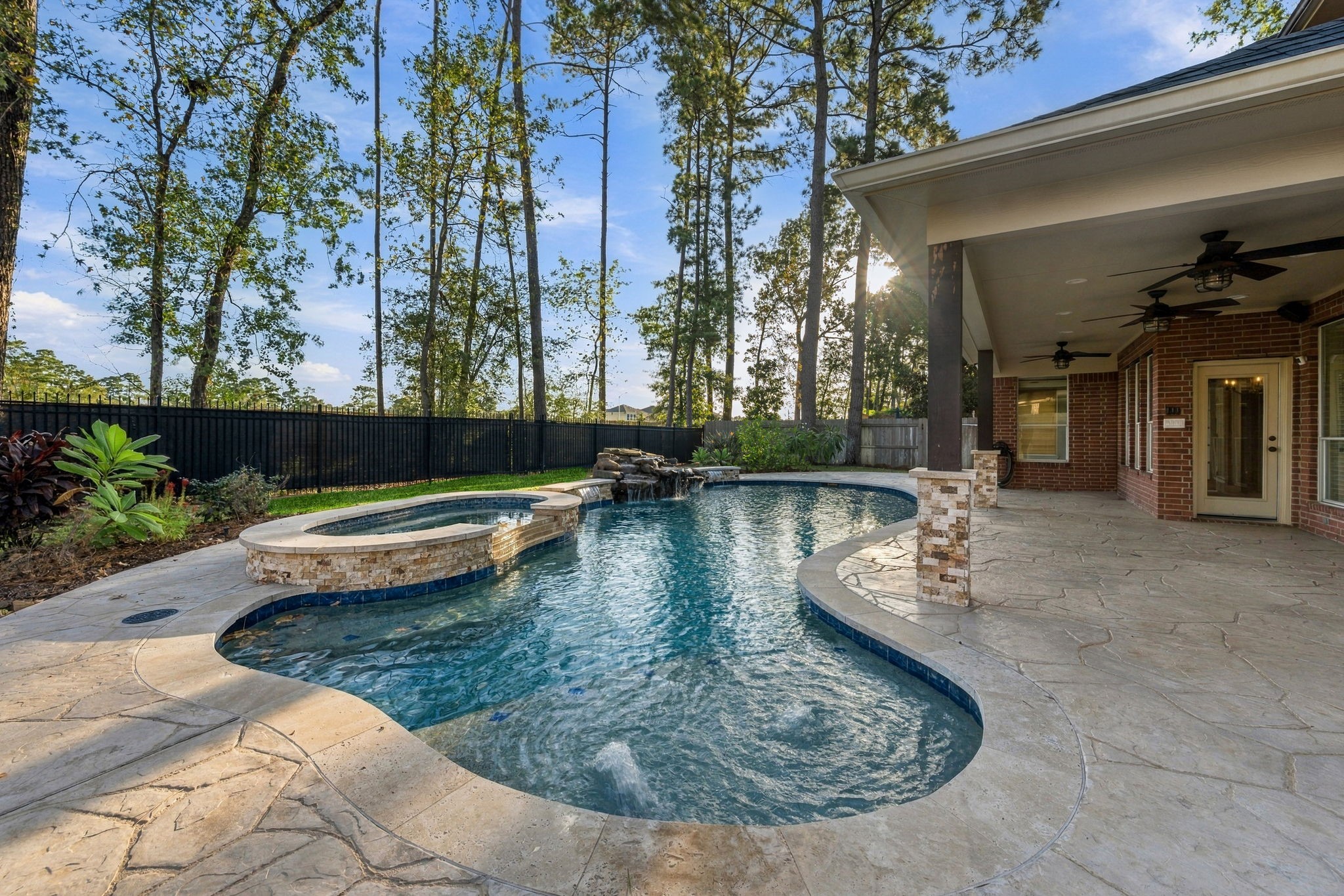 Experience luxury living with this stunning backyard oasis, featuring a sparkling pool, spa, and spacious covered patio perfect for entertaining.