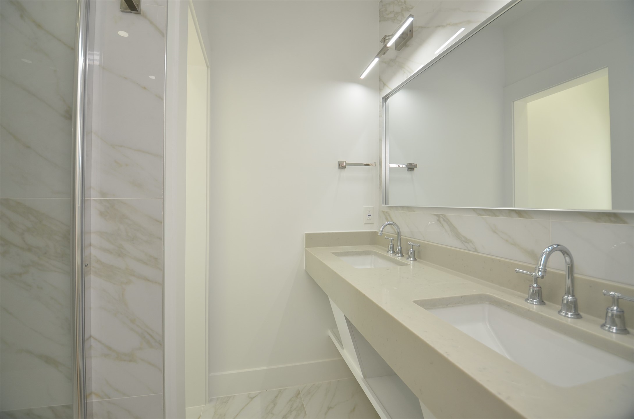 Beautiful modern primary bath with double vanity and a large walk-in shower, and smart Toilet.