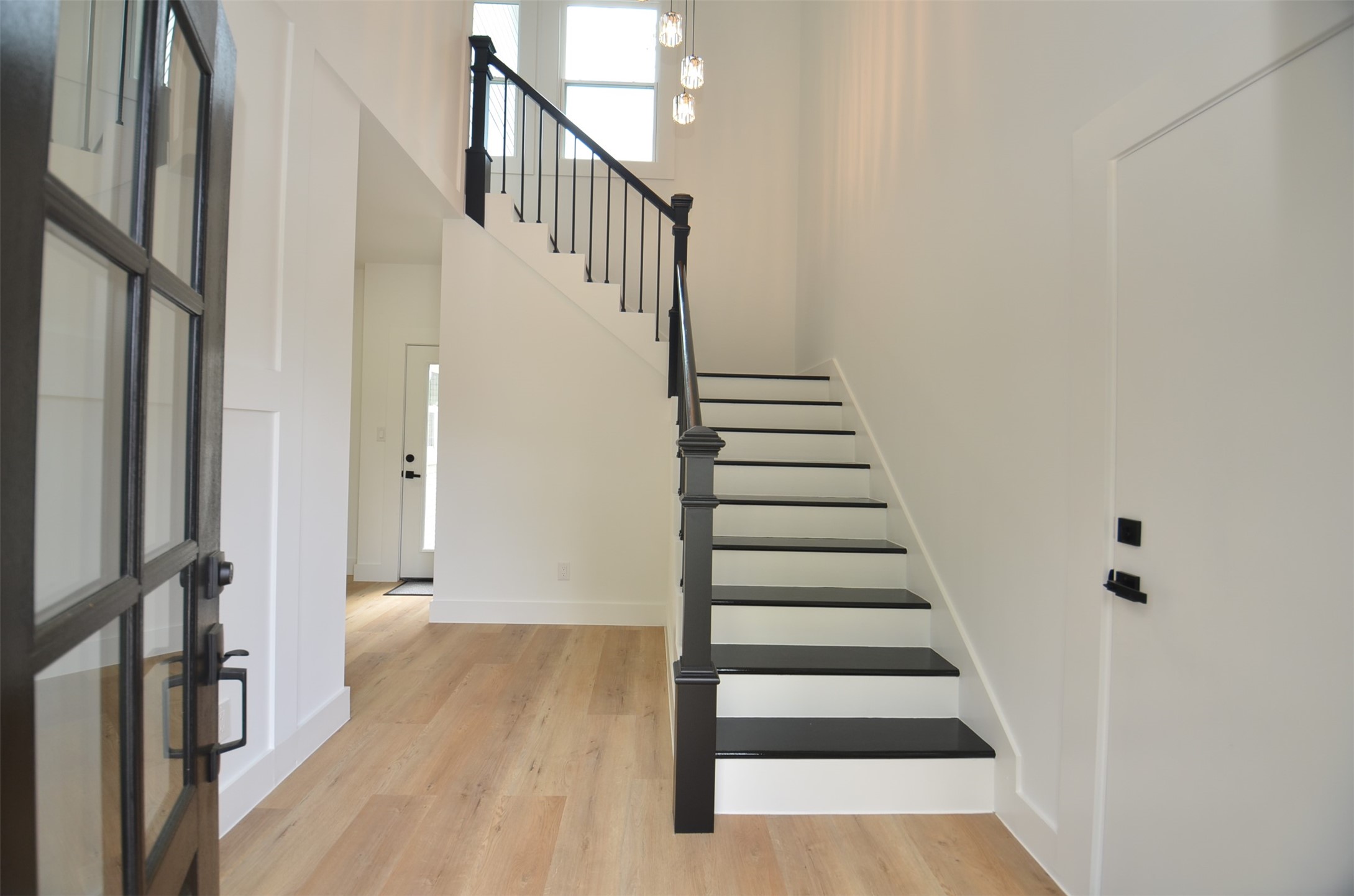 Bright entryway featuring high ceilings and elegant staircase