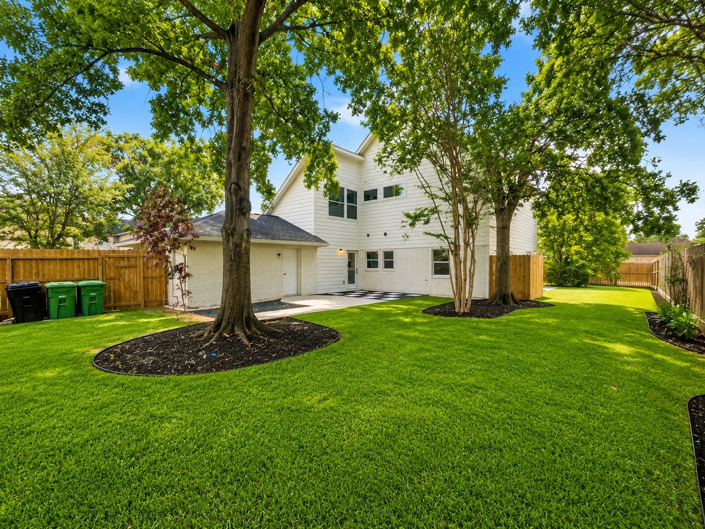 Enjoy a huge backyard with beautiful mature trees and ample space to create a custom outdoor living experience.