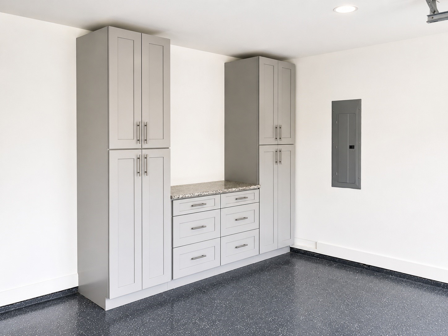 Custom built-in cabinetry with quartz countertop, ample storage, and a durable epoxy floor.